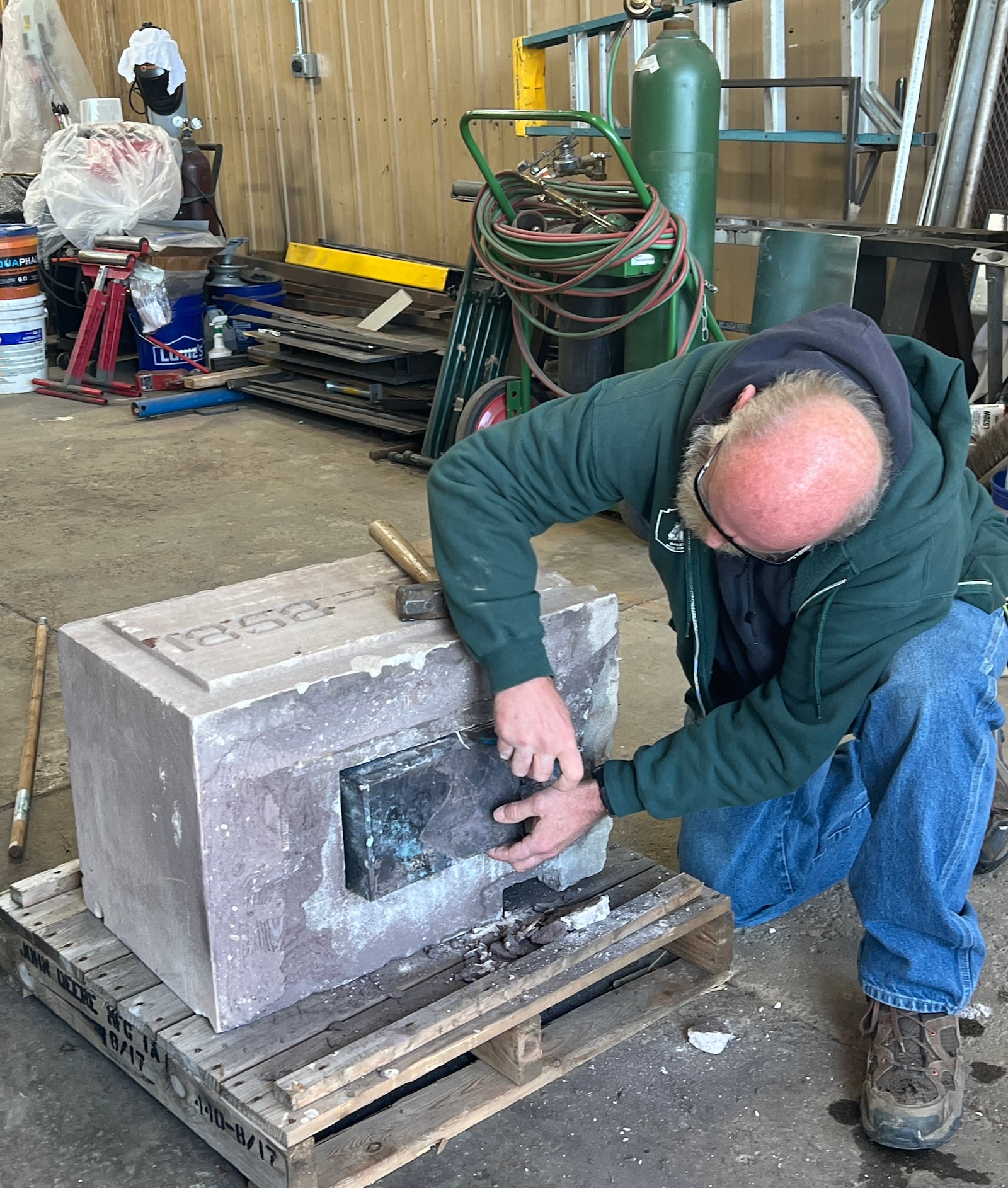 Kenny Pace of Greene County Services cuts open the former Greeneview South Elementary cornerstone to retrieve a time capsule, dated 1915. CONTRIBUTED