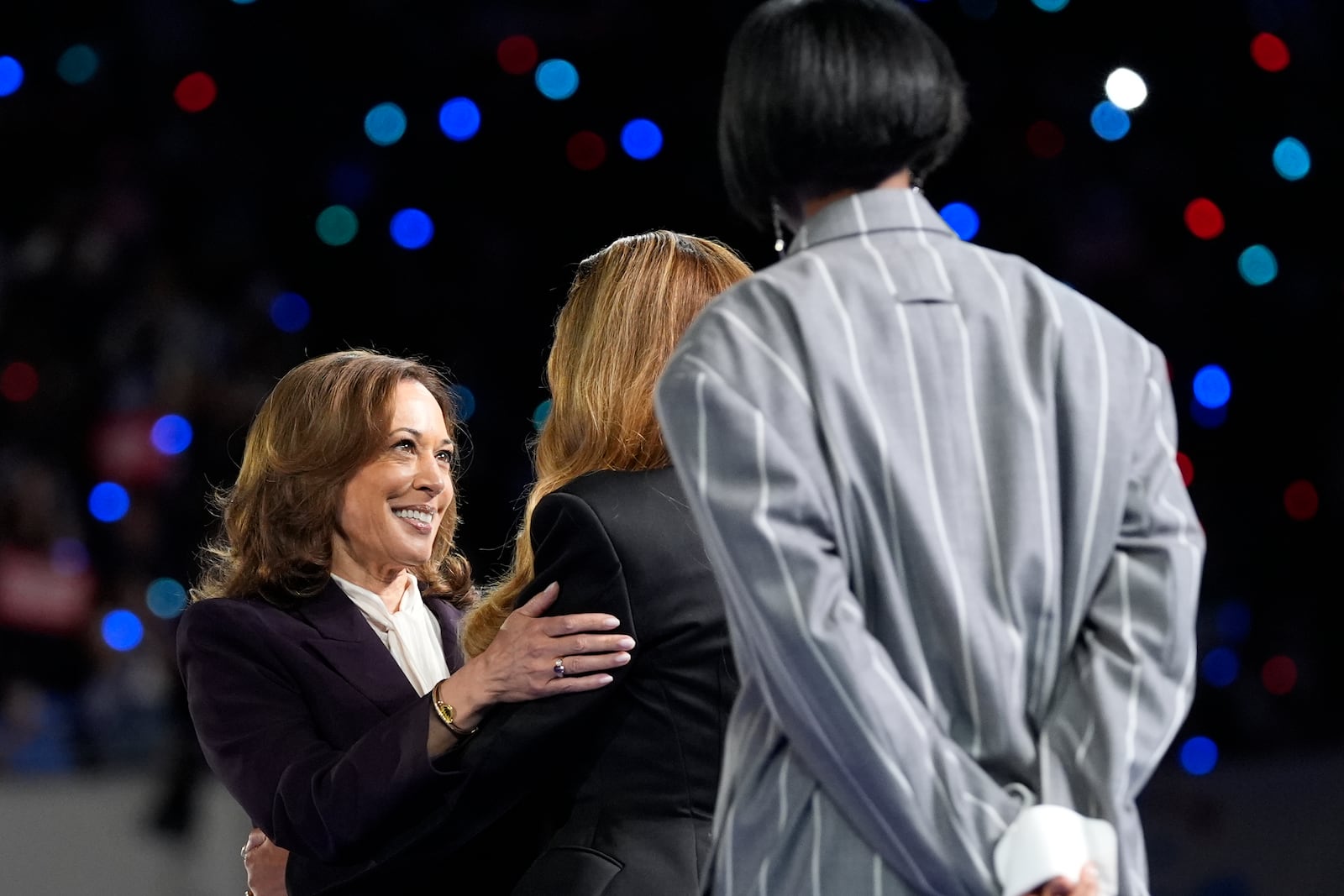 Democratic presidential nominee Vice President Kamala Harris, left, greeting musical artists Beyonce, center, and Kelly Rowland, right, on stage at a campaign event in Houston, Friday, Oct. 25, 2024. (AP Photo/Susan Walsh)