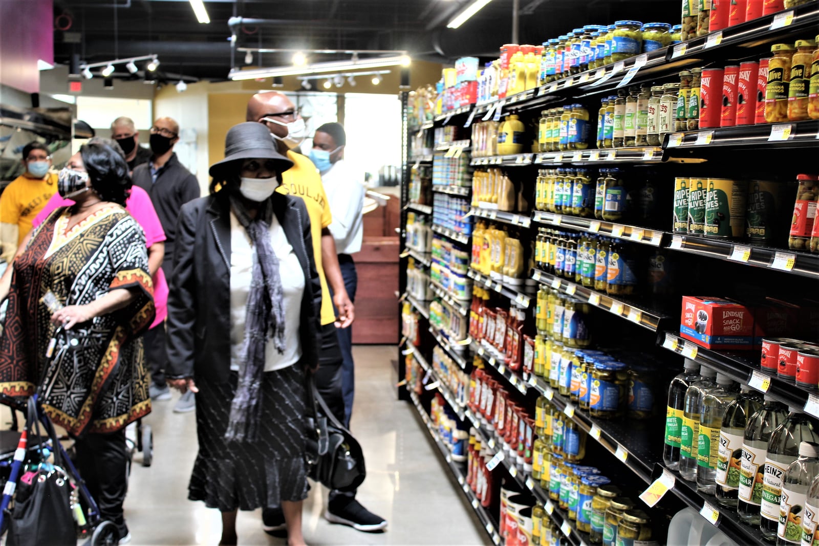 Visitors tour the Gem City Market on Wednesday, after supporters announced the food cooperative will host a grand opening on May 12. CORNELIUS FROLIK / STAFF