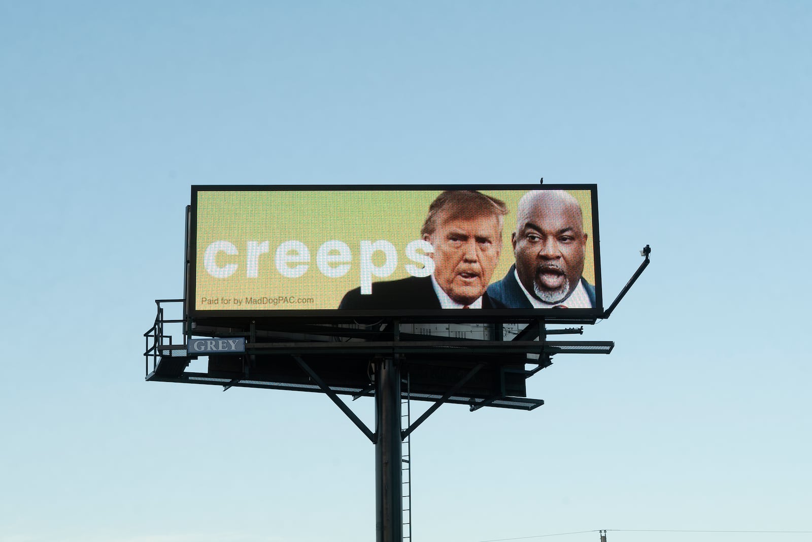 A billboard linking former President Donald Trump and Republican gubernatorial nominee Mark Robinson looms U.S. 1 in Youngsville, N.C., on Monday, Oct. 14, 2024. Trump has boasted that his U.S. Supreme Court nominees overturned the nationwide right to abortion, and Robinson's controversial statements on abortion have been a focus of Democrats in the state. (AP Photo/Allen G. Breed)