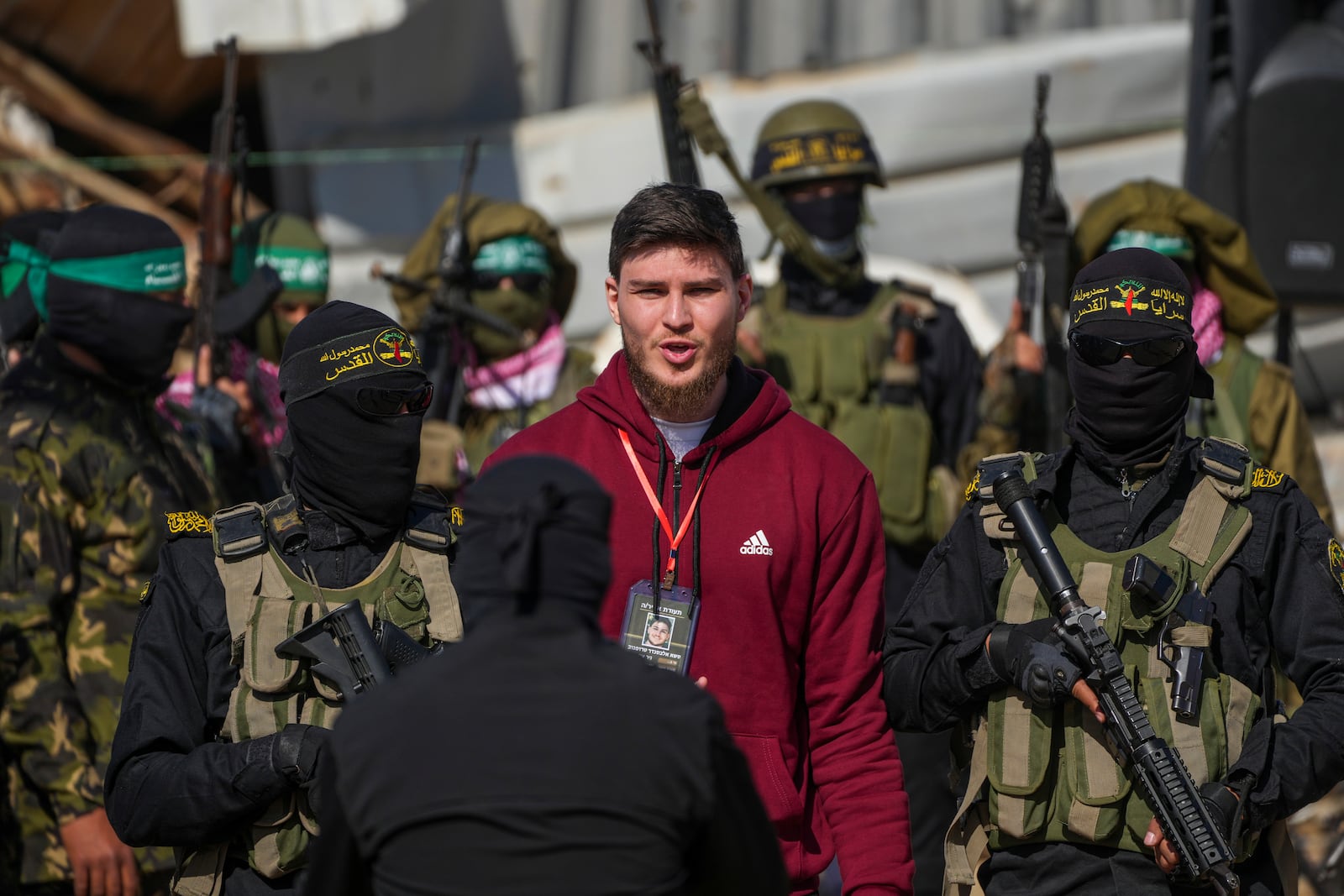 Alexander Troufanov, 29, who holds Israeli and Russian citizenship, is escorted by Hamas and islamic Jihad fighters as he is handed over to the Red Cross in Khan Younis, Gaza Strip, Saturday, Feb. 15, 2025. (AP Photo/Abdel Kareem Hana)