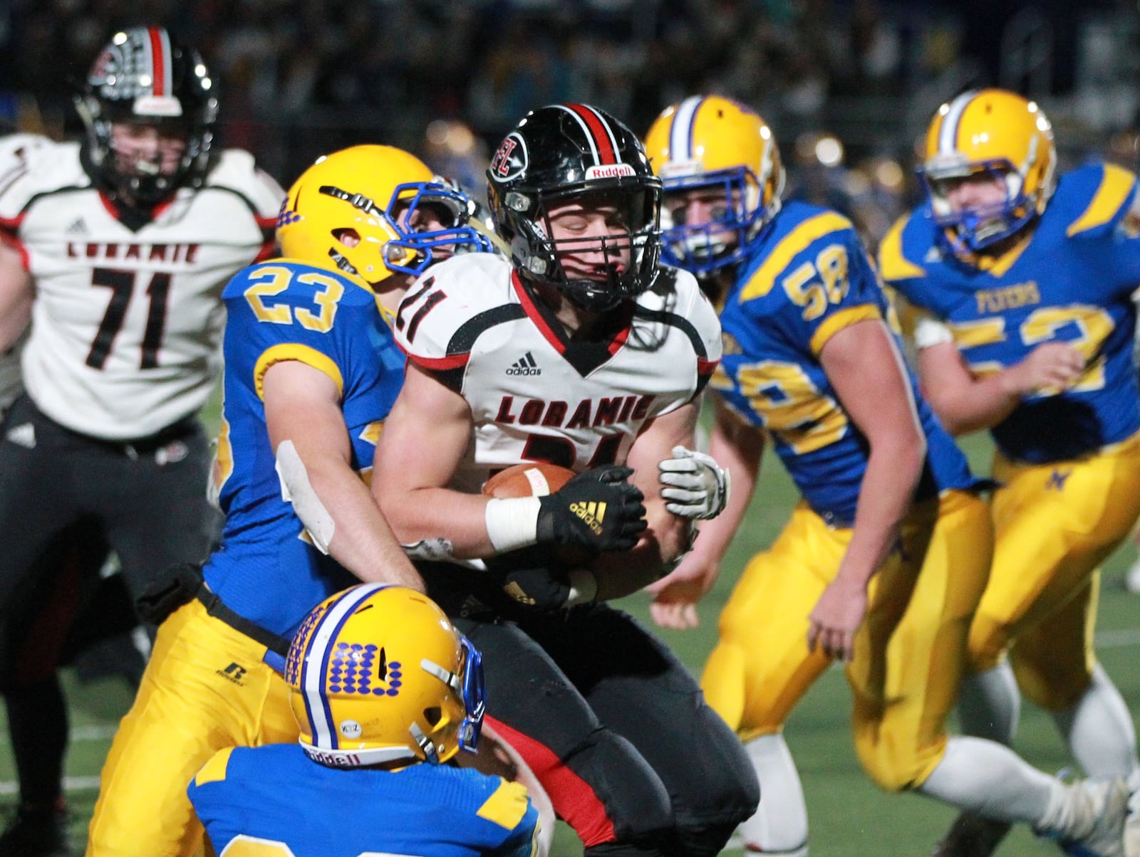 Nate Meyer of Fort Loramie (with ball) draws Grant Meier (23) of Marion Local. Marion Local defeated Fort Loramie 24-21 in OT in a Division VII, Region 28 high school football regional semifinal at St. Marys Memorial on Saturday, Nov. 16, 2019. MARC PENDLETON / STAFF