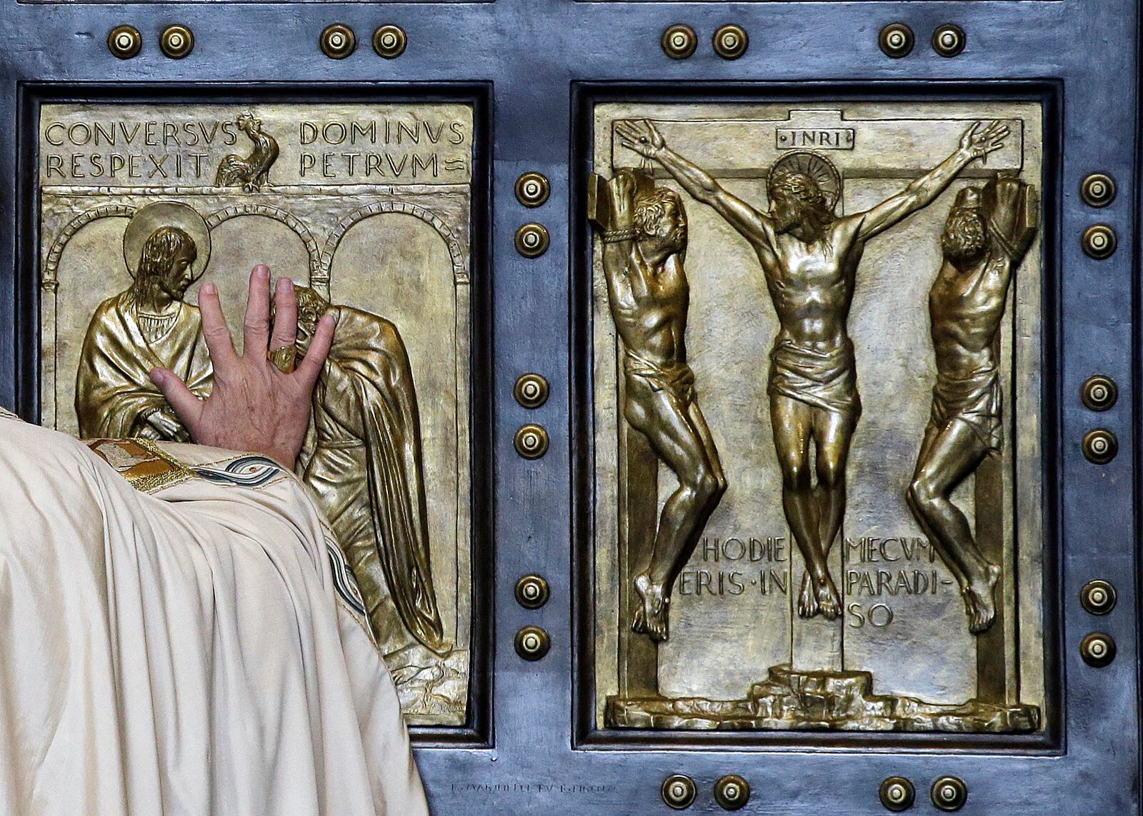 FILE - Pope Francis pushes open the Holy Door of St. Peter's Basilica, formally launching the Holy Year of Mercy, at the Vatican, Tuesday, Dec. 8, 2015. (AP Photo/Gregorio Borgia, File)