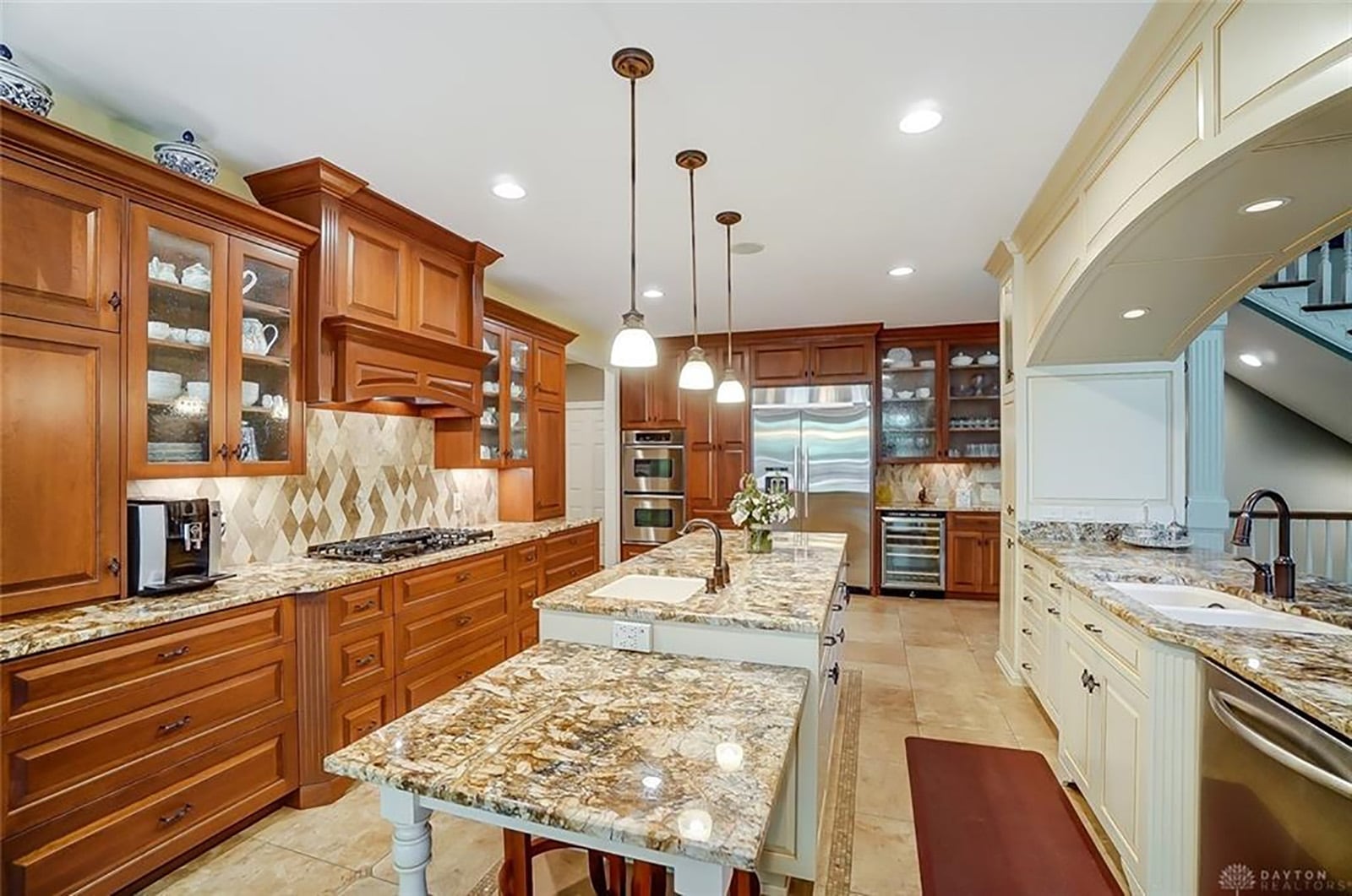 A pass-through with cabinetry and counter seating divides the great room from the kitchen. The kitchen offers high-end appliances, custom cabinetry with pull-outs and storage for many needs. There is also an island with a vegetable sink and table setting extension. CONTRIBUTED PHOTO