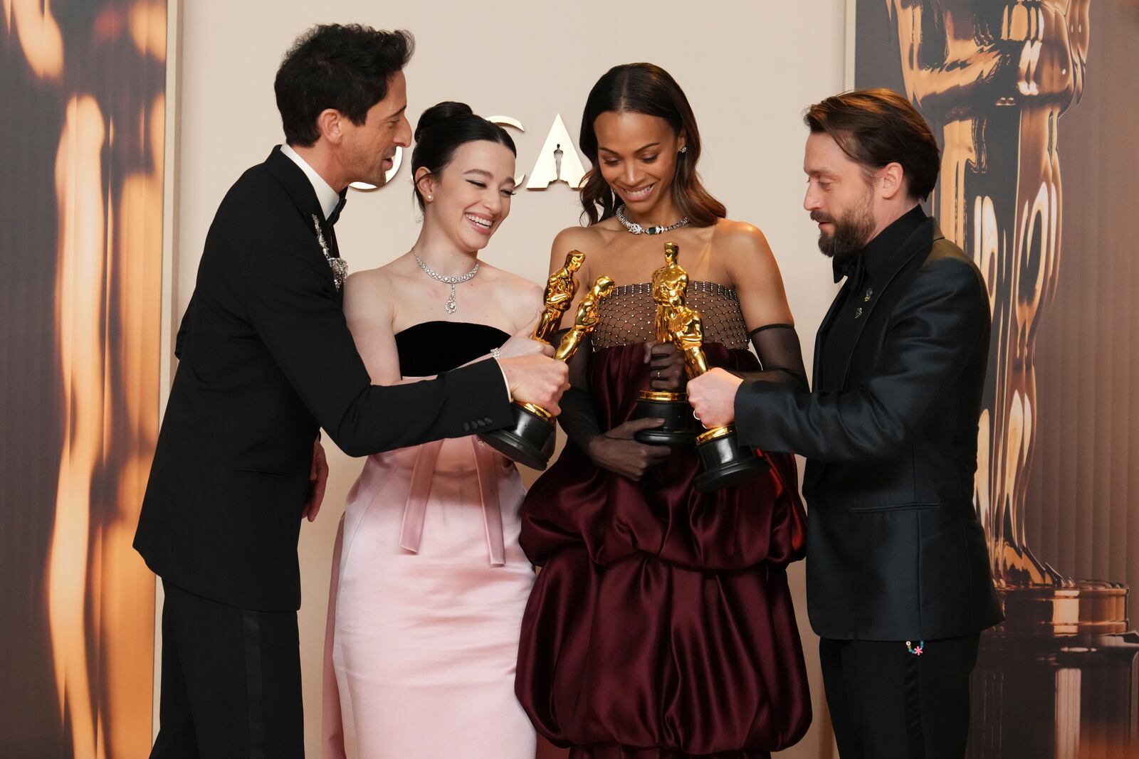 Adrien Brody, from left, winner of the award for best performance by an actor in a leading role for "The Brutalist," Mikey Madison, winner of the award for best performance by an actress in a leading role for "Anora," Zoe Saldana, winner of the award for best performance by an actress in a supporting role for "Emilia Perez," and Kieran Culkin, winner of the award for best performance by an actor in a supporting role for "A Real Pain," pose in the press room at the Oscars on Sunday, March 2, 2025, at the Dolby Theatre in Los Angeles. (Photo by Jordan Strauss/Invision/AP)