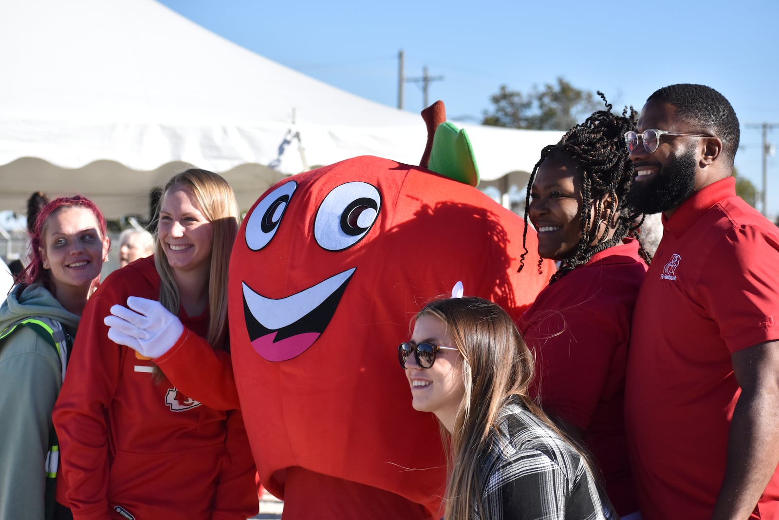 Attendees at the Dayton Foodbank Inc.'s recent groundbreaking ceremony for the Foodbank's new community building pose for a photo with the Foodbank's mascot. SAM WILDOW\STAFF