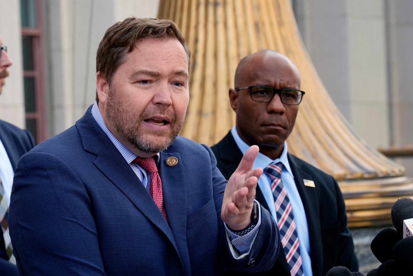 Acting U.S. Attorney Joseph T. McNally, left, and FBI Assistant Director Akil Davis discuss court filings related to the Palisades Fire investigation outside the U.S. Courthouse in downtown Los Angeles on Friday, Jan. 31, 2025. (AP Photo/Damian Dovarganes)