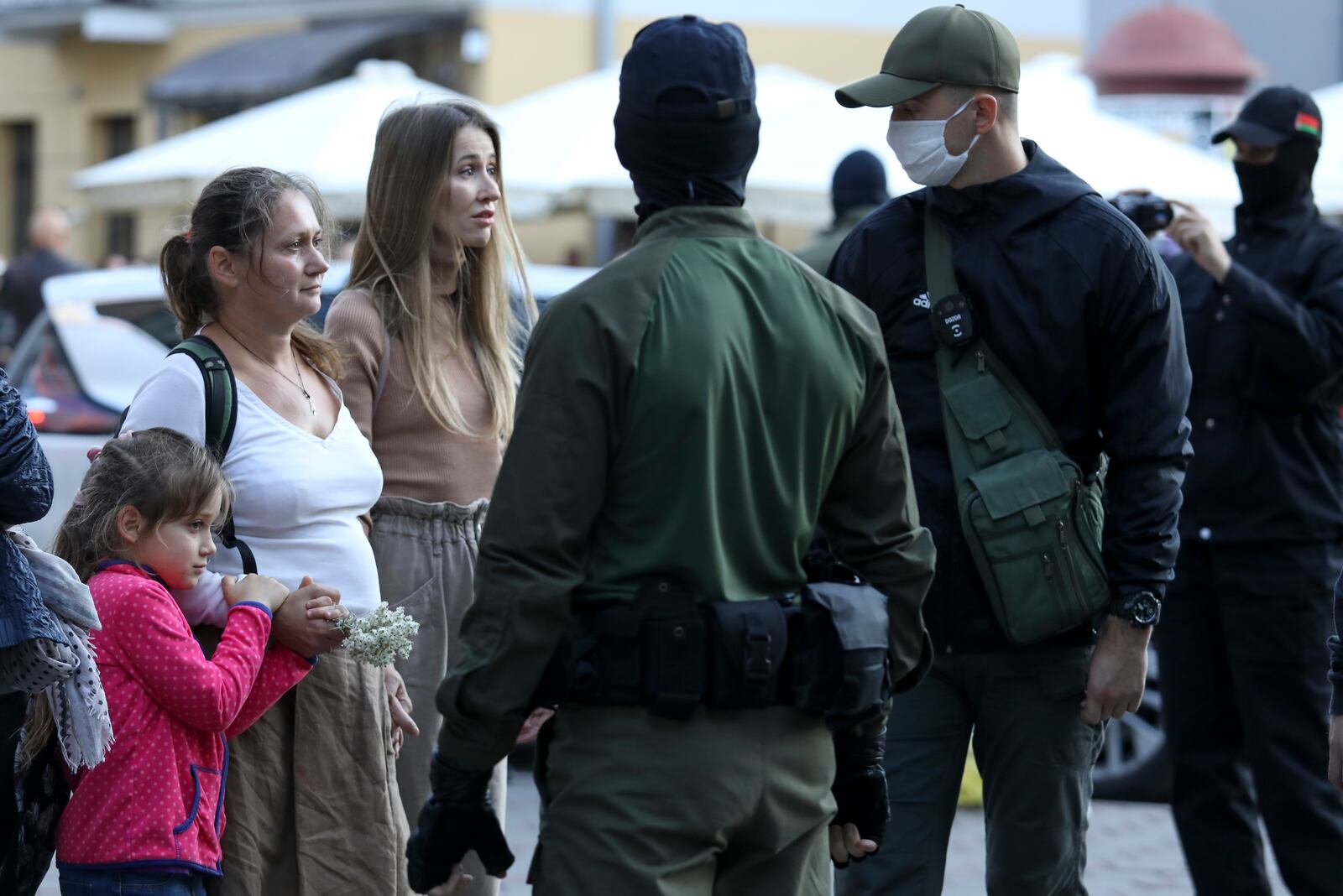 Women, one of them with her child, speak to police officers during a rally in support of Maria Kolesnikova, and other members of the Coordination Council created by the opposition to facilitate talks with Lukashenko on a transition of power, was detained Monday in the capital of Minsk with two other council members, in Minsk, Belarus, Wednesday, Sept. 9, 2020. The leading opposition candidate in Belarus' disputed presidential election said Wednesday that the political tension in her country should be solved internally, by the Belarusian people, but she did not exclude the need for future international mediation. (AP Photo)