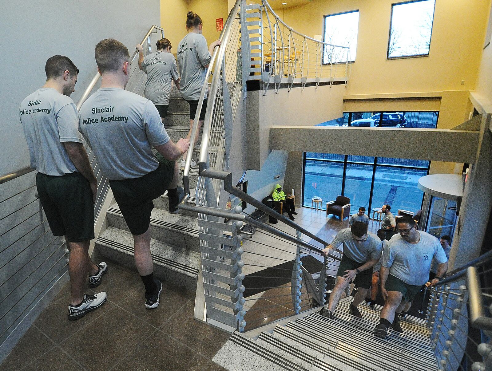 Cadets stretch their legs on the stairs before morning physical training, Thursday, Jan. 11, 2024. MARSHALL GORBY\STAFF