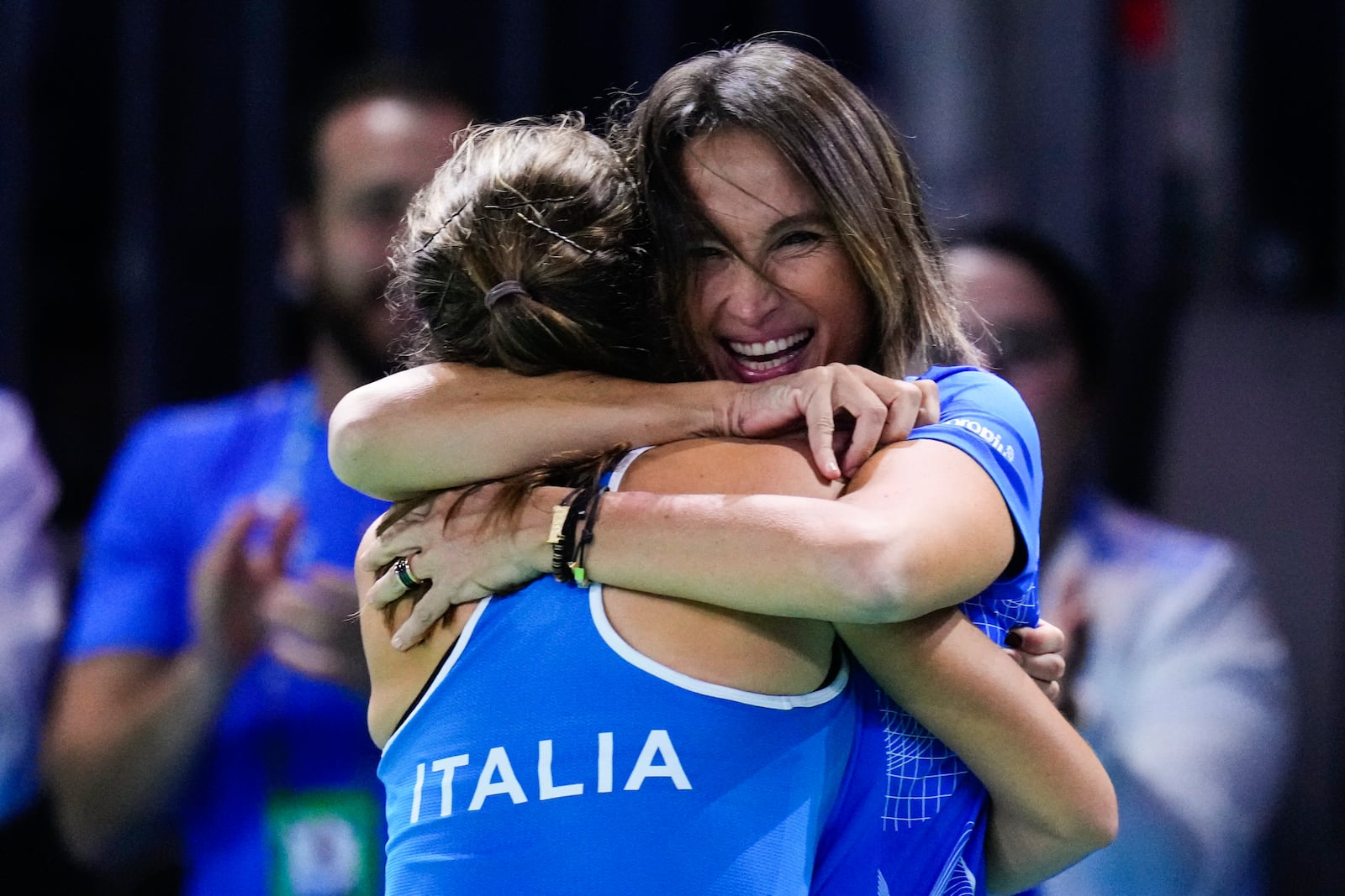 Italy's captain Tathiana Garbin, right, congratulates teammate Italy's Lucia Bronzetti after winning a match against Slovakia's Viktoria Hruncakova during the Billie Jean King Cup final at the Martin Carpena Sports Hall in Malaga, southern Spain, on Wednesday, Nov. 20, 2024. (AP Photo/Manu Fernandez)