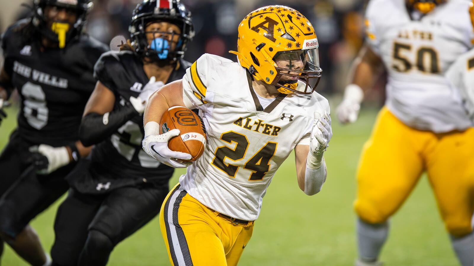 Alter High School sophomore running back Noah Jones carries the ball during the Division IV state championship game against Cleveland Glenville on Saturday night at Tom Benson Hall of Fame Stadium in Canton. CONTRIBUTED PHOTO BY MICHAEL COOPER