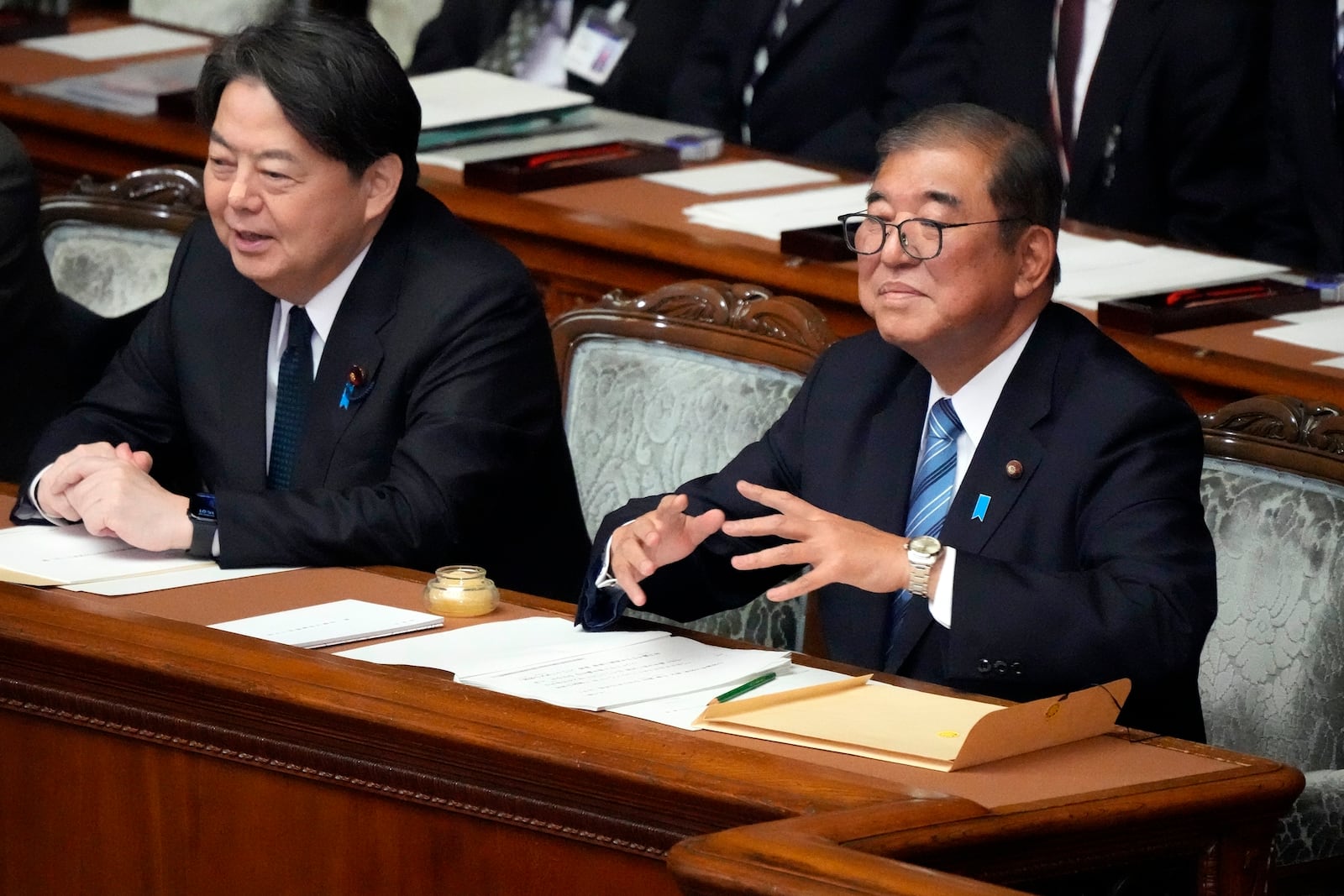 Japanese Prime Minister Shigeru Ishiba, right, gestures before delivering his policy speech at the extraordinary session of parliament's lower house Friday, Nov. 29, 2024, in Tokyo. (AP Photo/Eugene Hoshiko)