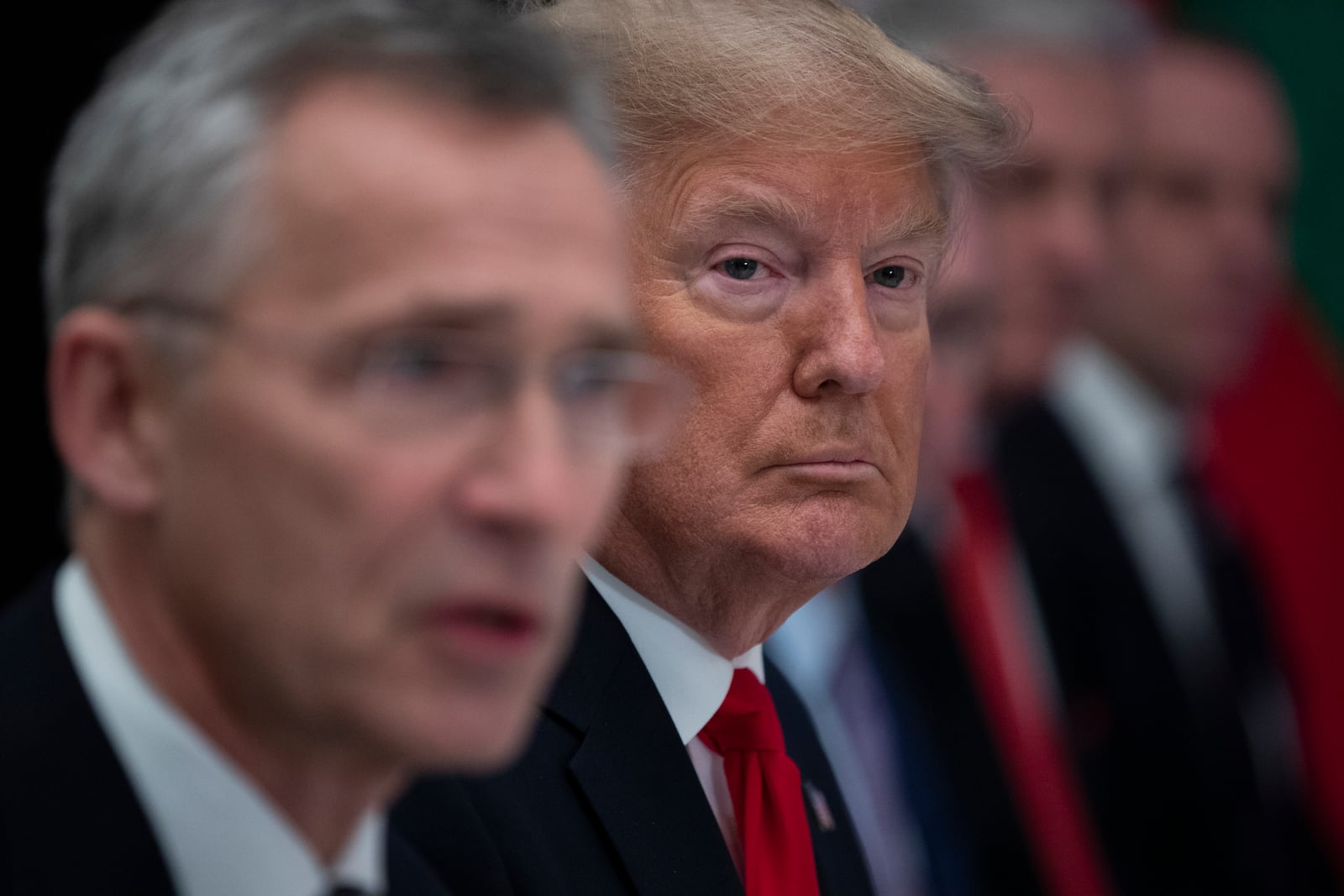 FILE - President Donald Trump listens as NATO Secretary General Jens Stoltenberg speaks during a working lunch with NATO members that have met their financial commitments to the the organization, at The Grove, Wednesday, Dec. 4, 2019, in Watford, England. (AP Photo/ Evan Vucci, File)