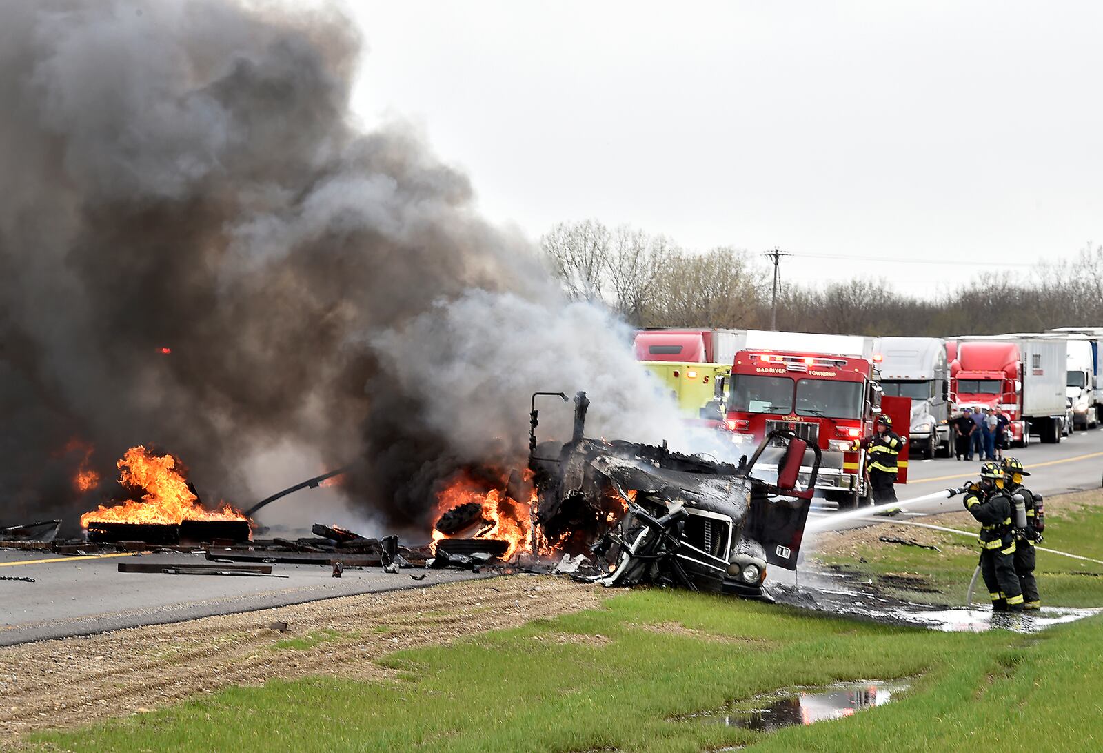 Mad River Township firefighters extinguish the flames that consumed a tractor trailer and car after the vehicles collided head-on in April 2015, on eastbound I-70 near the Enon Road entrance. The driver of the car, Christopher Coleman of Xenia, was killed in the crash but the truck driver escaped before the rig caught fire. Eastbound I-70 was closed for several hours because of the accident. Bill Lackey/Staff