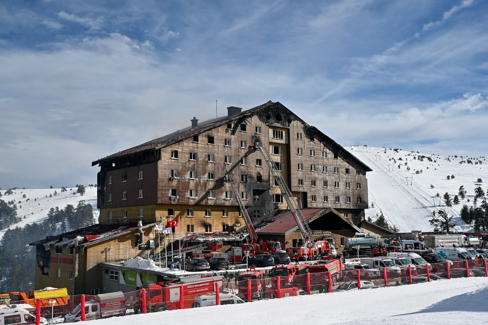 Firefighters work at the scene after a fire broke out at a hotel in the ski resort of Kartalkaya, located in Bolu province, northwest Turkey, on Tuesday, Jan. 21, 2025. (Mert Gokhan Koc/DIA Photo via AP)