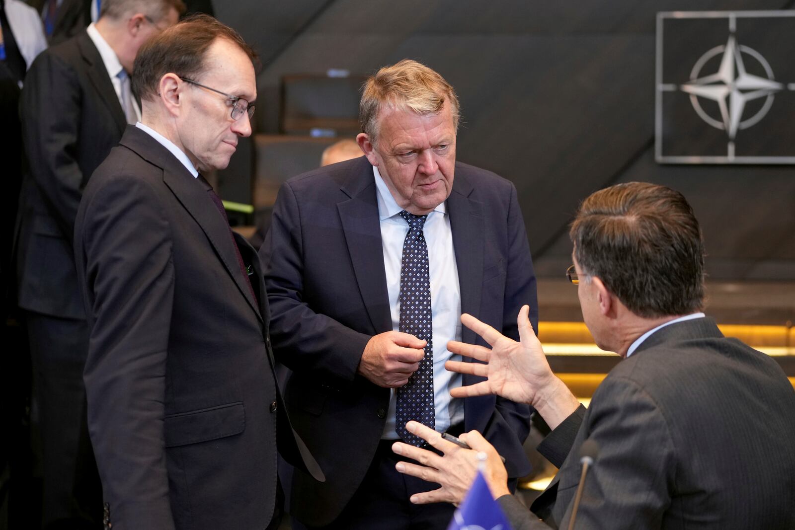 NATO Secretary General Mark Rutte, right, speaks with Denmark's Foreign Minister Lars Lokke Rasmussen, center, during a meeting of NATO foreign ministers at NATO headquarters in Brussels, Wednesday, Dec. 4, 2024. (AP Photo/Virginia Mayo)