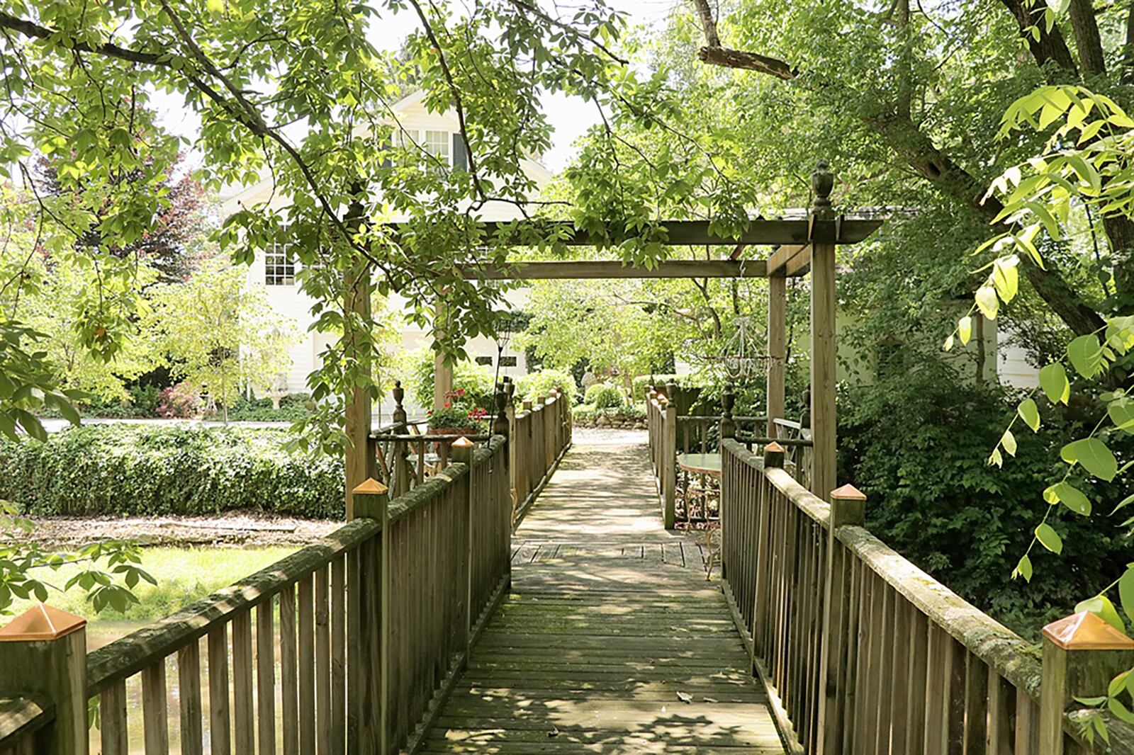 Along the river edge is a patio-like fishing deck, and steps lead to the 70-foot wooden bridge that crosses the river artery to the island where a fire pit and reading garden are starting points to a few walking trails. CONTRIBUTED PHOTO BY KATHY TYLER