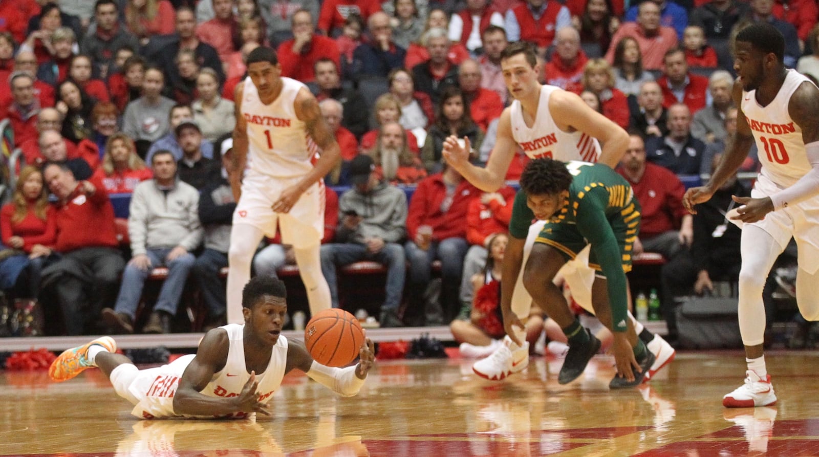 Dayton’s Dwayne Cohill dives for a loose ball against George Mason on Wednesday, Jan. 23, 2019, at UD Arena. David Jablonski/Staff