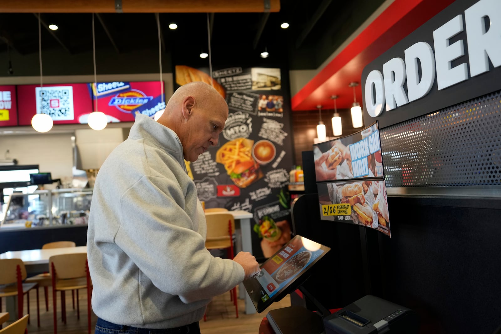 Brian Blair, of Akron, Ohio, enters his food order at a Sheetz convenience store, Thursday, Oct. 17, 2024, in Bethlehem, Pa. (AP Photo/Matt Slocum)