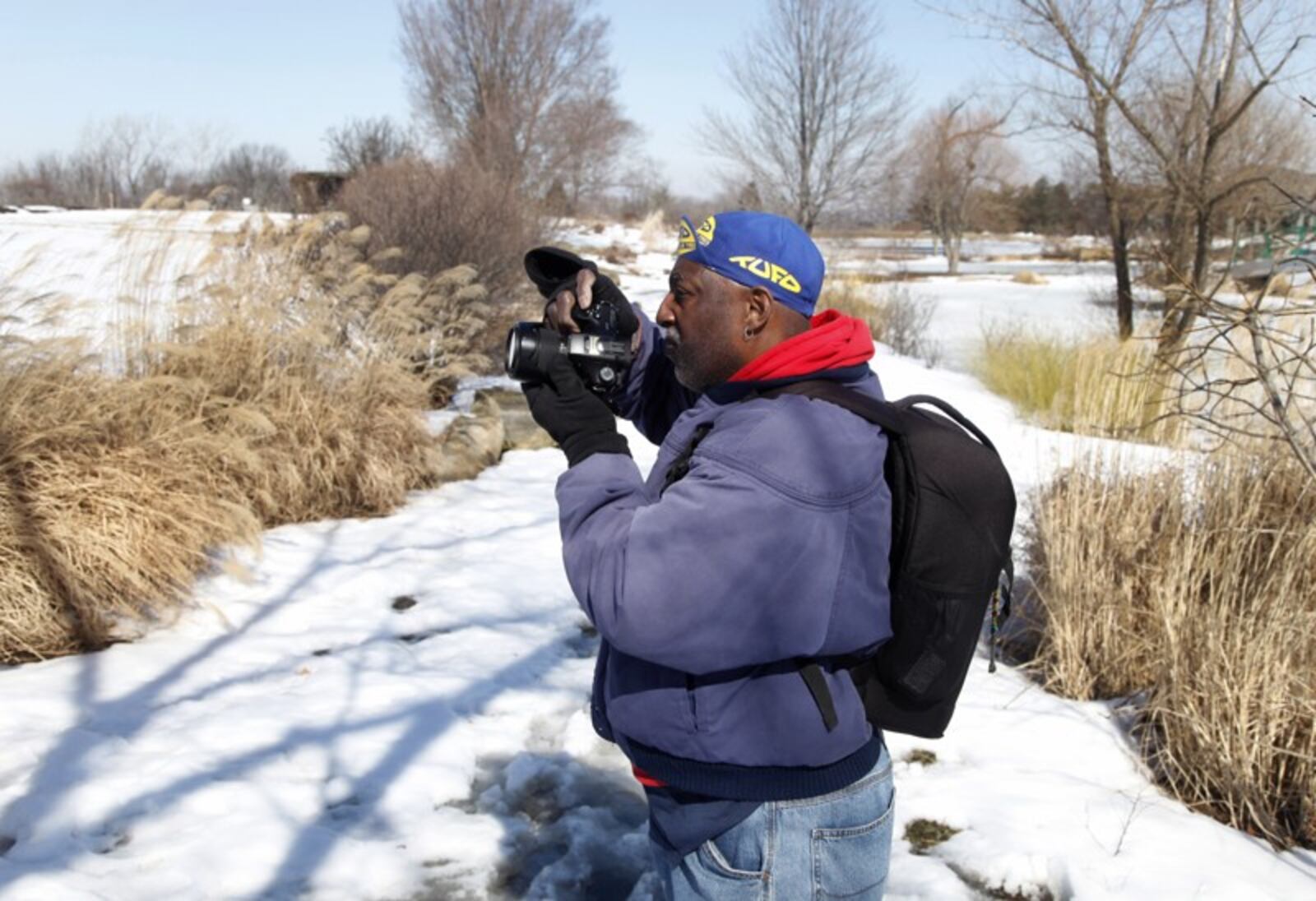 Terry Flucas, a photography enthusiast from Englewood, points his camera toward scenic views at Cox Arboretum MetroPark.