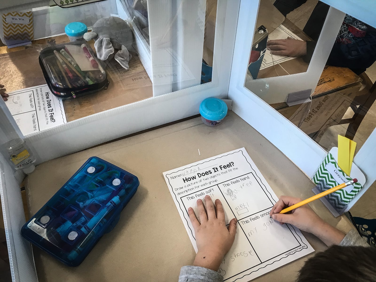 Students at Orchard Park Elementary School sit in class with protective plastic around their desks Tuesday March 2, 2021. The school is now open for in person learning after 12 months of COVID-19 restrictions.