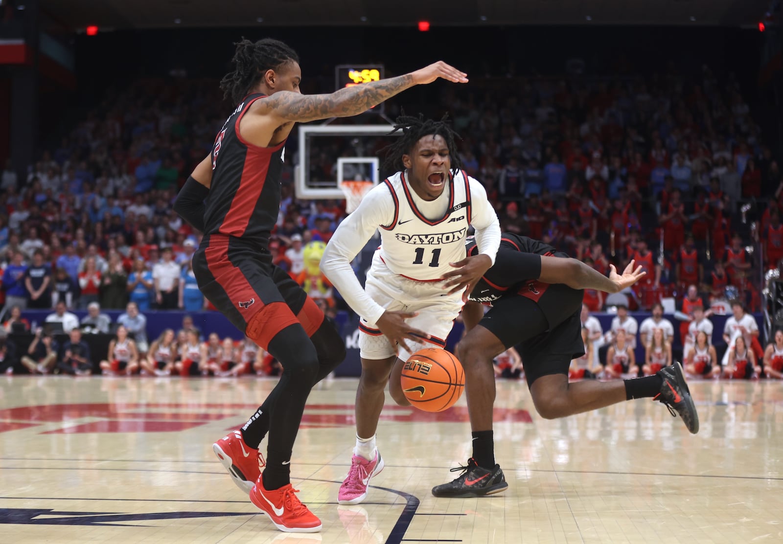 Dayton's Malachi Smith draws a foul in the second half against Saint Joseph’s on Friday, Jan. 24, 2025, at UD Arena. David Jablonski/Staff