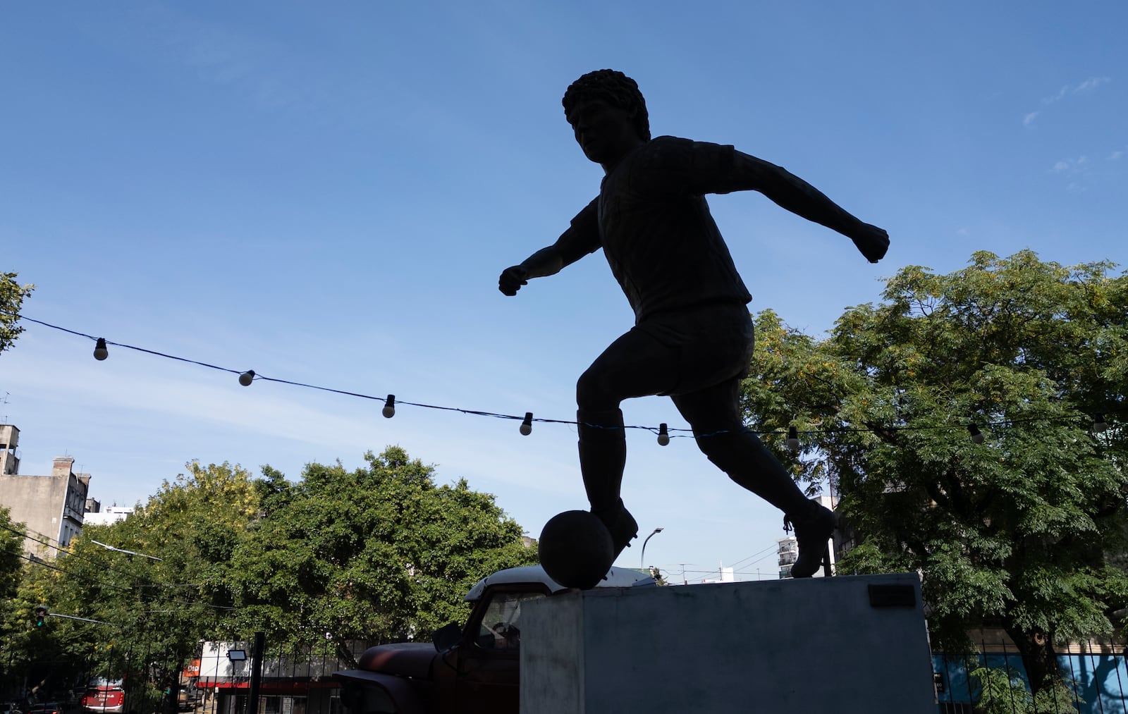 A sculpture of late soccer star Diego Maradona stands on the terrace of a bar in Buenos Aires, Argentina, Tuesday, March 11, 2025. (AP Photo/Rodrigo Abd)