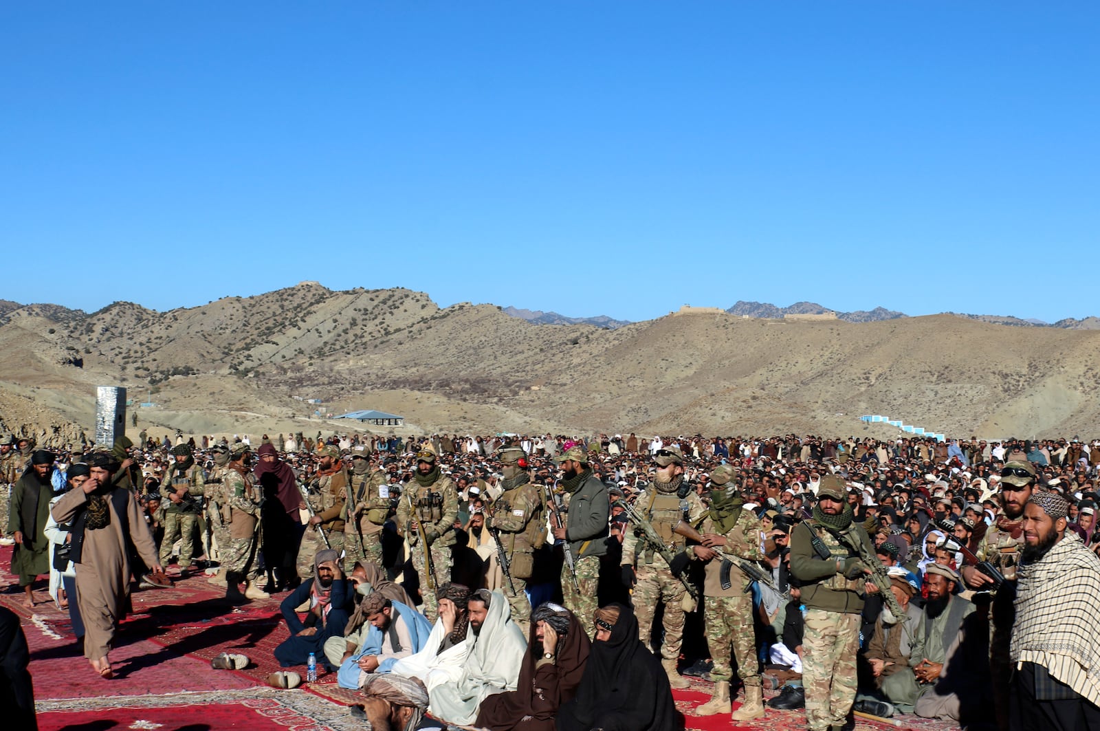 Taliban fighters stand guard during the funeral prayers of Khalil Haqqani, the minister for refugees and repatriation, during his funeral procession in eastern Paktia province, Afghanistan, Thursday, Dec. 12, 2024. (AP Photo/Saifullah Zahir)