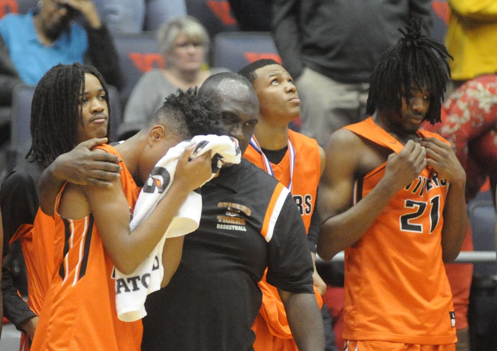 Stivers coach Felix Turner consoles Allen Lattimore following a 72-63 loss to Cincinnati Deer Park in a boys high school basketball D-III district final at UD Arena last season. MARC PENDLETON / STAFF