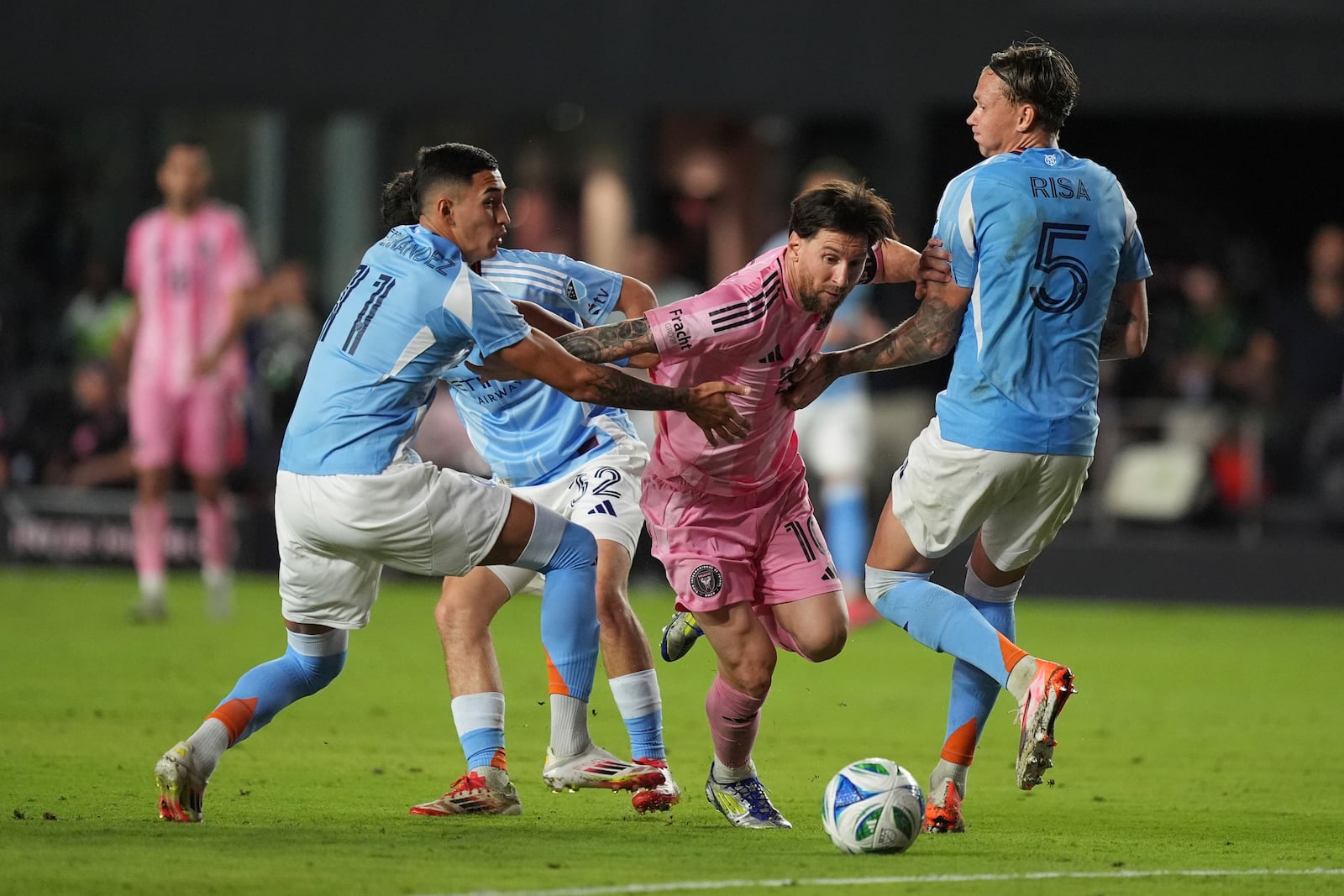 Inter Miami forward Lionel Messi comes under pressure from New York City FC defender Birk Risa (5) and forward Julian Fernandez as they battle during the second half of an MLS soccer match, Saturday, Feb. 22, 2025, in Fort Lauderdale, Fla. (AP Photo/Rebecca Blackwell)