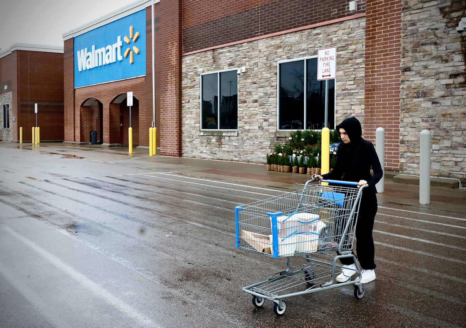 A shopper leaves the Beavercreek Walmart store on Tuesday, Nov. 19, 2024. MARSHALL GORBY / STAFF