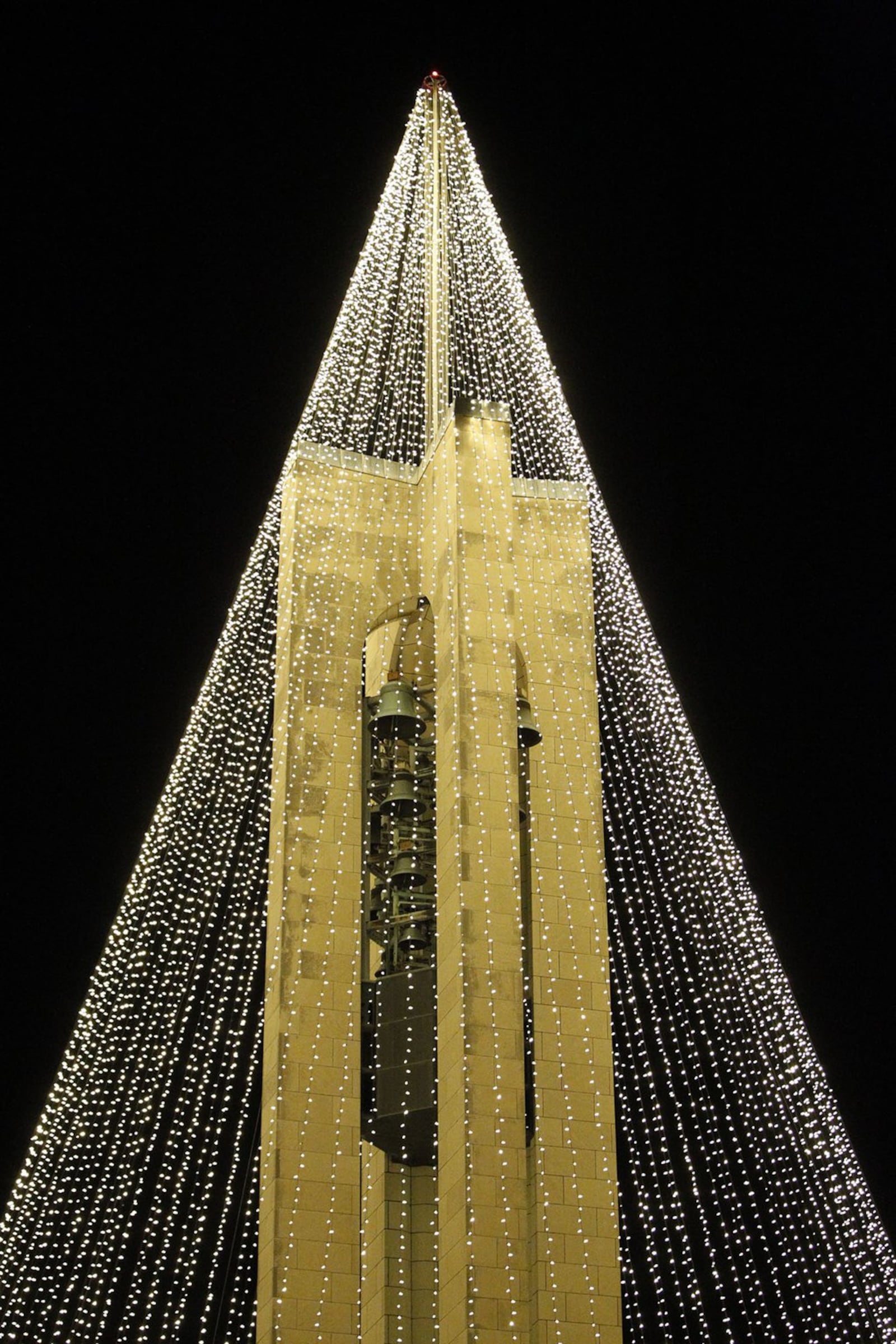 Dayton History has transformed the Deeds Carillon at Carillon Park into a huge lighted Christmas Tree. TY GREENLEES / STAFF