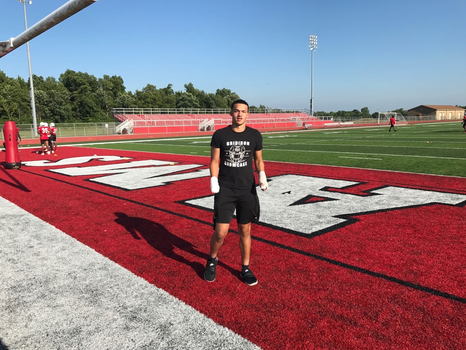 Issiah Evans stands at the edge of the Trotwood Madison field during summer workout the other evening. Although he suffered serious injuries, including the loss of his right hand, in a fireworks accident just 19 days ago, and had ACL surgery in the spring, he vows he will play again his season. Last year, as a sophomore linebacker, he was one of the leaders of the team. He’s also a 4.2 GPA student  Tom Archdeacon photo)