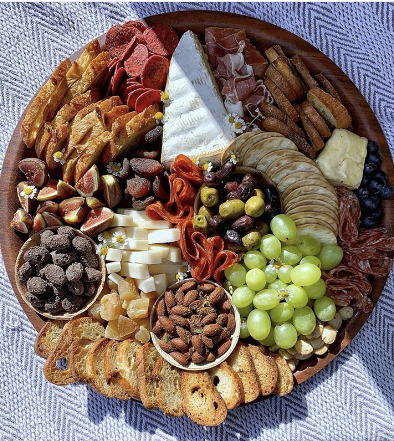 A charcuterie board is literally the easiest thing to throw together and, when done right, makes a gorgeous and delectable centerpiece. Pick 3 different kinds of cheese, three different meats, grab some figs, a handful of grapes, a few rosemary sprigs and you are in business. CONTRIBUTED BY KAITLIN SKILKEN