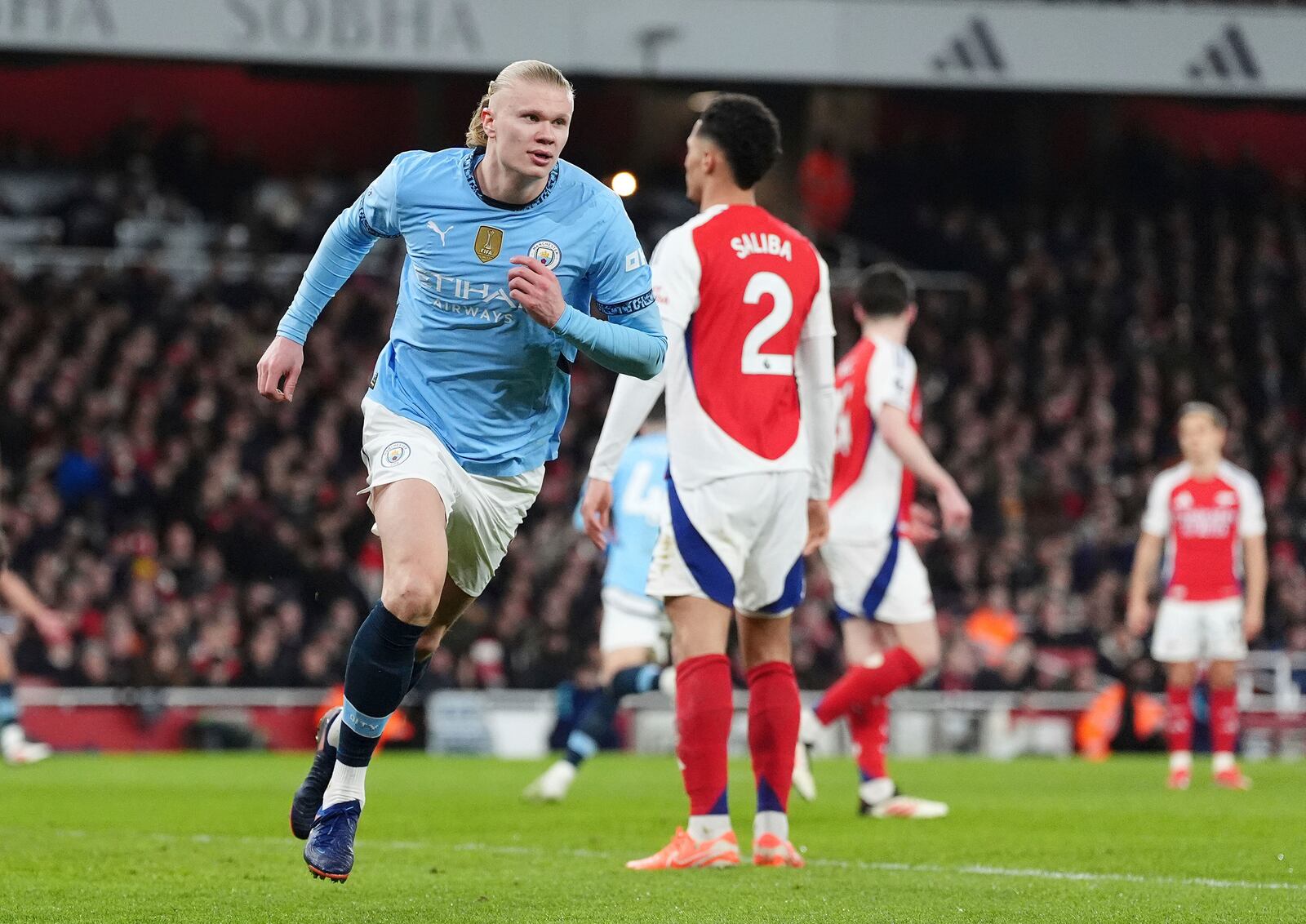 Manchester City's Erling Haaland celebrates scoring his side's first goal during the English Premier League soccer match between Arsenal and Manchester City at the Emirates stadium in London, Sunday, Feb. 2, 2025. (Adam Davy/PA via AP)