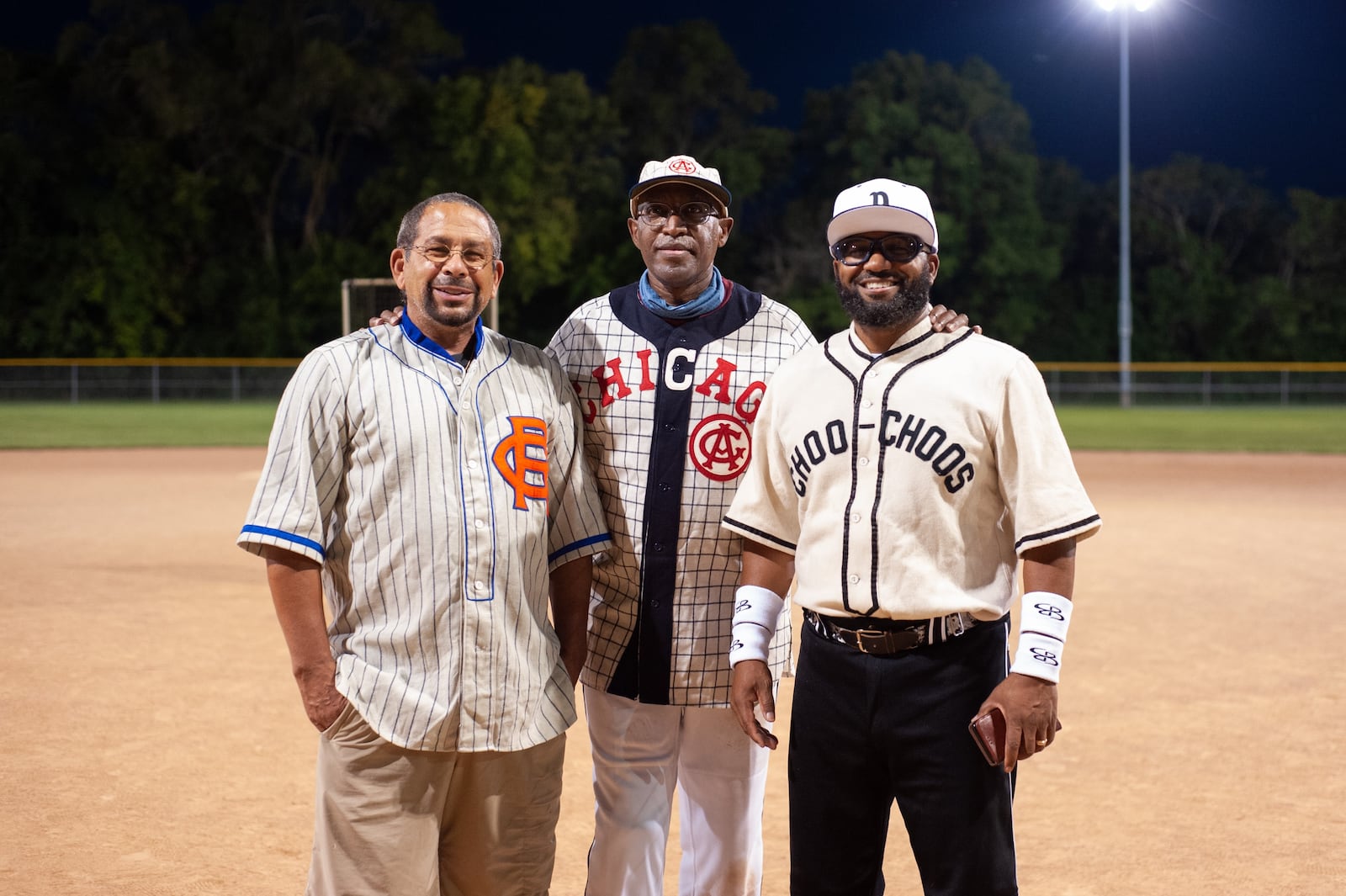 From left, Sinclair biology professor Dr. Mark Smith, Sinclair Chief Diversity officer and Senior Advisor to the President Michael Carter and Derek Allen, Sinclair Chairperson and Professor of Culinary Arts and Hospitality wear Negro League jerseys from Carter's collection. Aaron Paschal/CONTRIBUTED