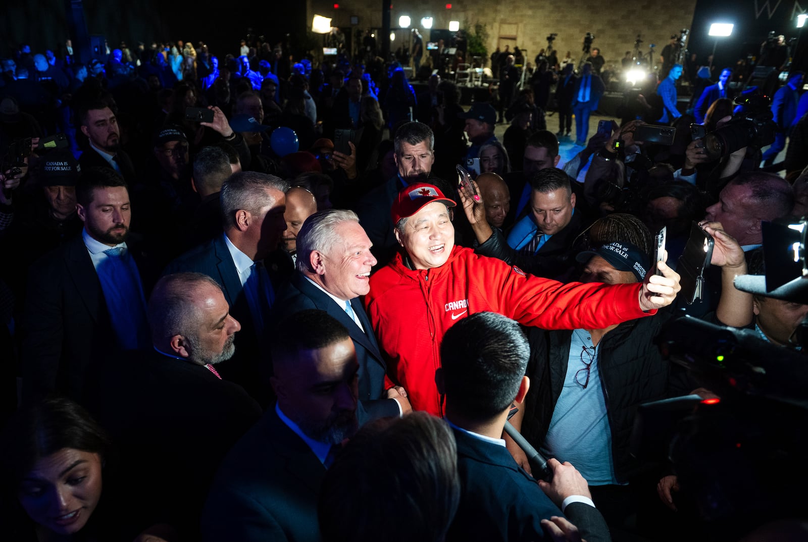 Newly re-elected Ontario Premier Doug Ford takes photos with supporters at his election night event in Toronto on Thursday, Feb. 27, 2025. (Laura Proctor/The Canadian Press via AP)