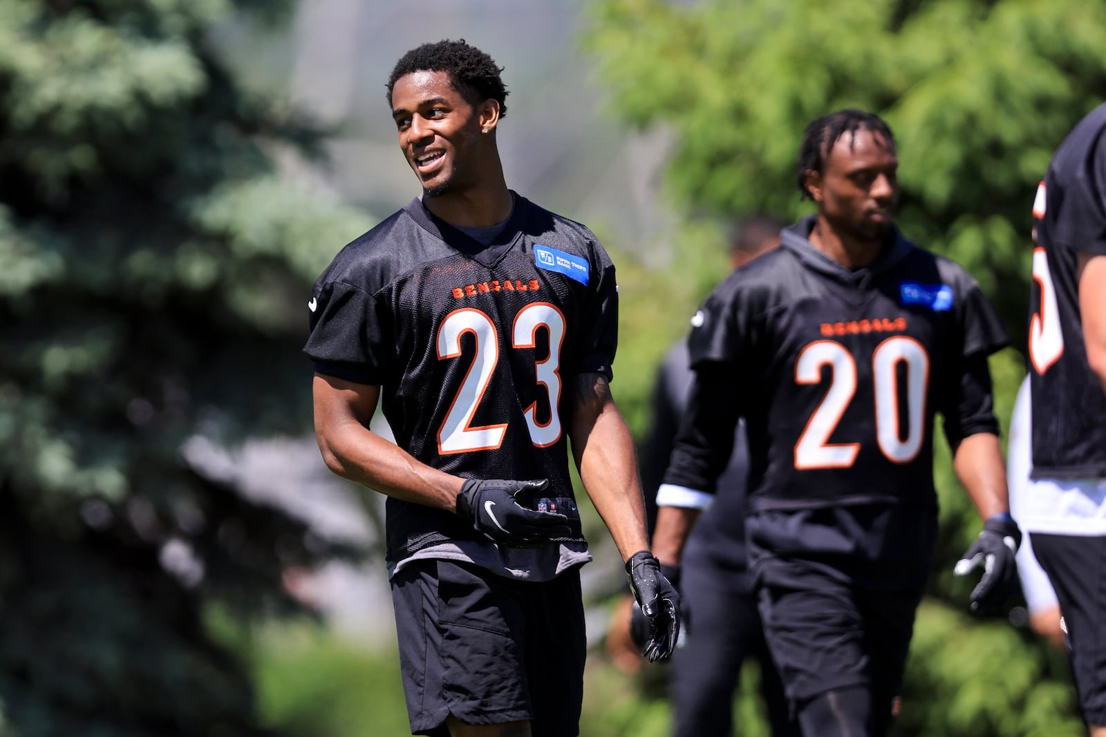 Cincinnati Bengals' Dax Hill talks with teammates during NFL football practice in Cincinnati, Tuesday, May 17, 2022. (AP Photo/Aaron Doster)