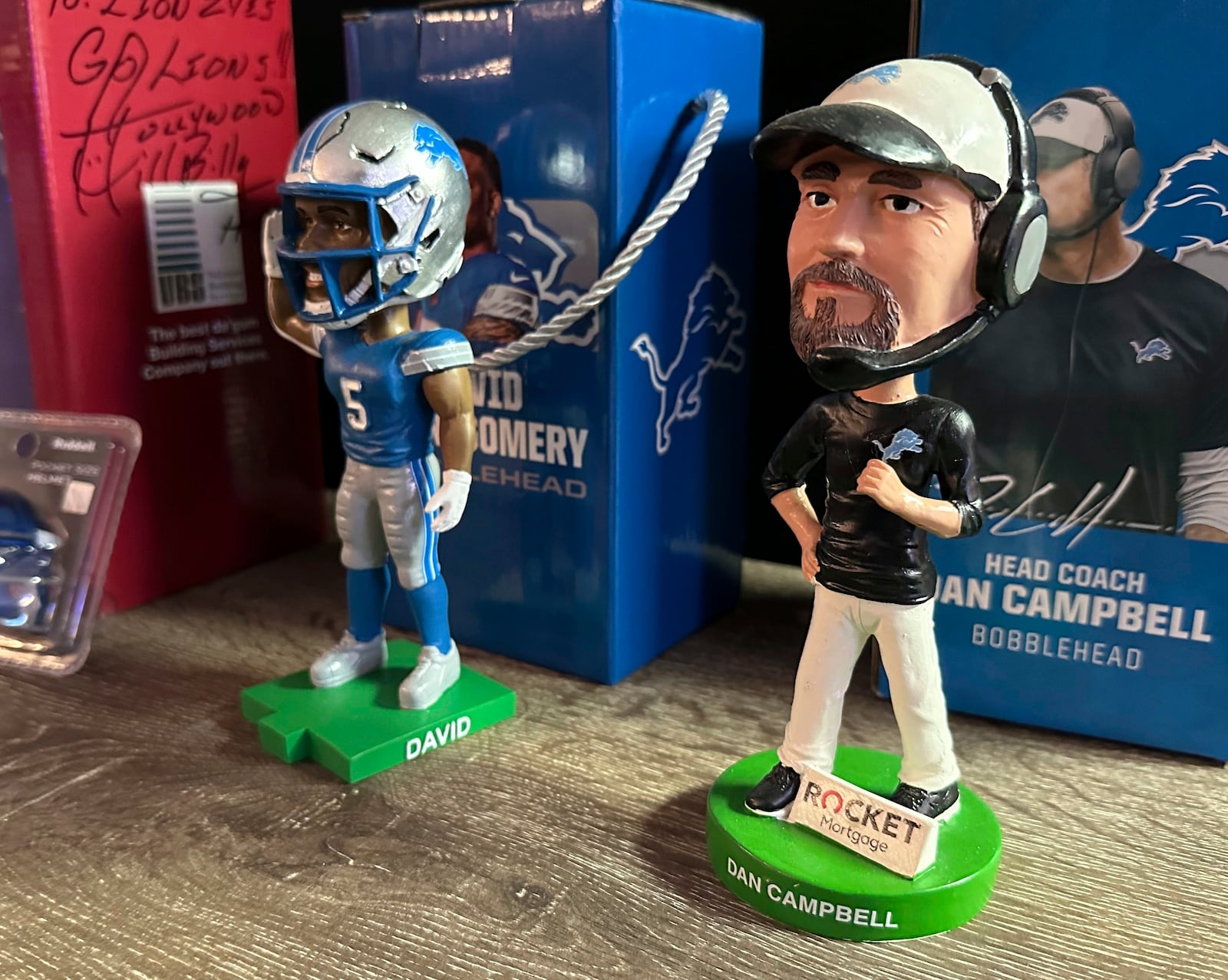 Bobbleheads depicting Detroit Lions NFL football coach Dan Campbell, right, and running back David Montgomery (5) are displayed in fan Rob Gonzales' basement Thursday, Jan. 16, 2025, in Frenchtown Township, Mich. (AP Photo/Mike Householder)