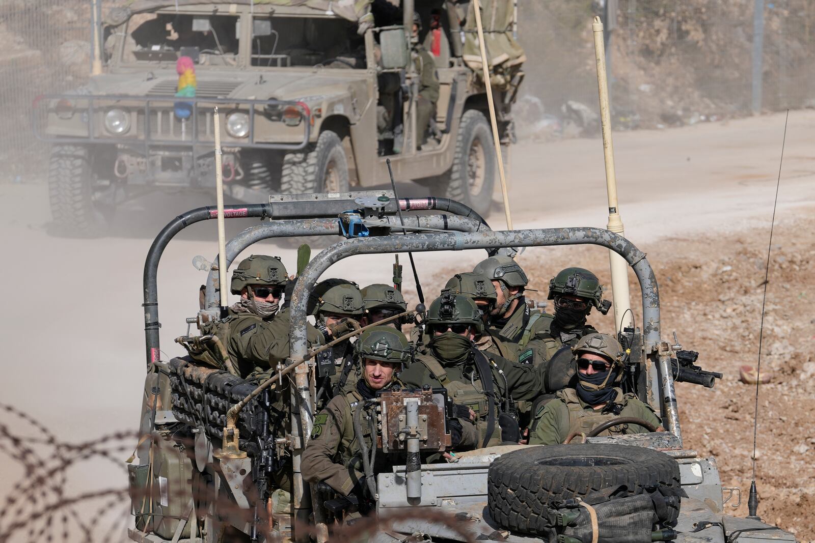 Israeli soldiers stand on armoured vehicles before crossing the security fence, moving towards the so-called Alpha Line that separates the Israeli-controlled Golan Heights from Syria, in the town of Majdal Shams, Thursday, Dec. 12, 2024. (AP Photo/Matias Delacroix)