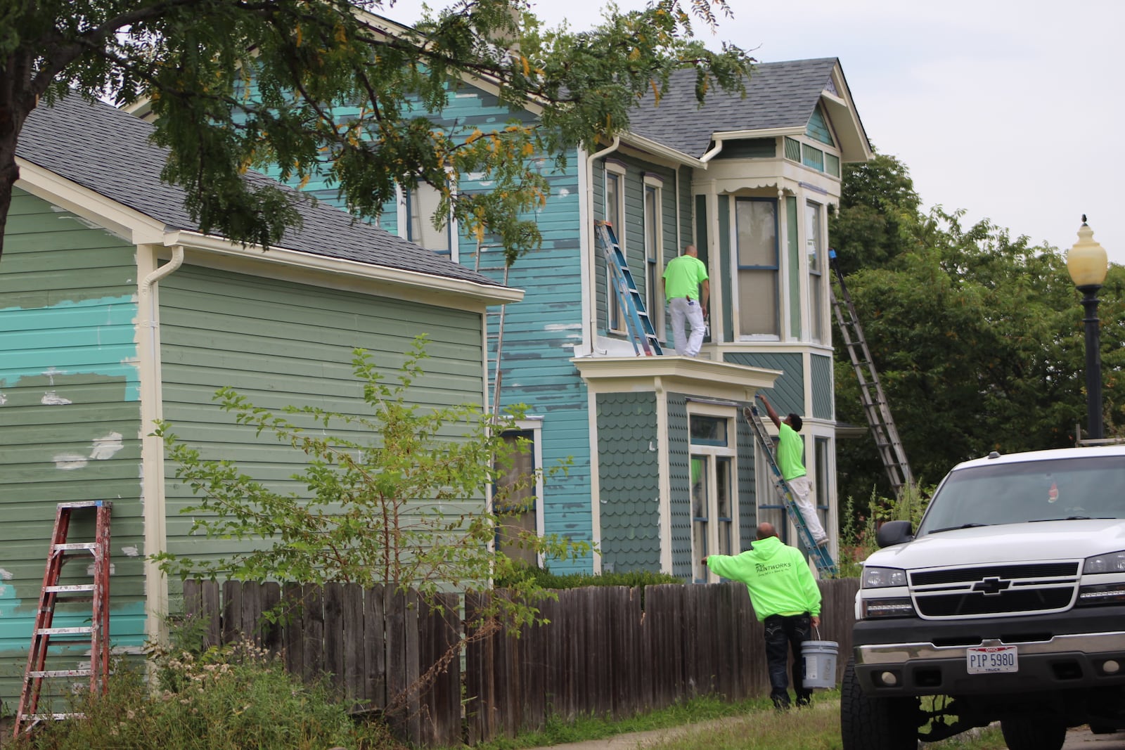 Crews on Friday worked on renovating a home in the Wright Dunbar Village neighborhood. CORNELIUS FROLIK / STAFF