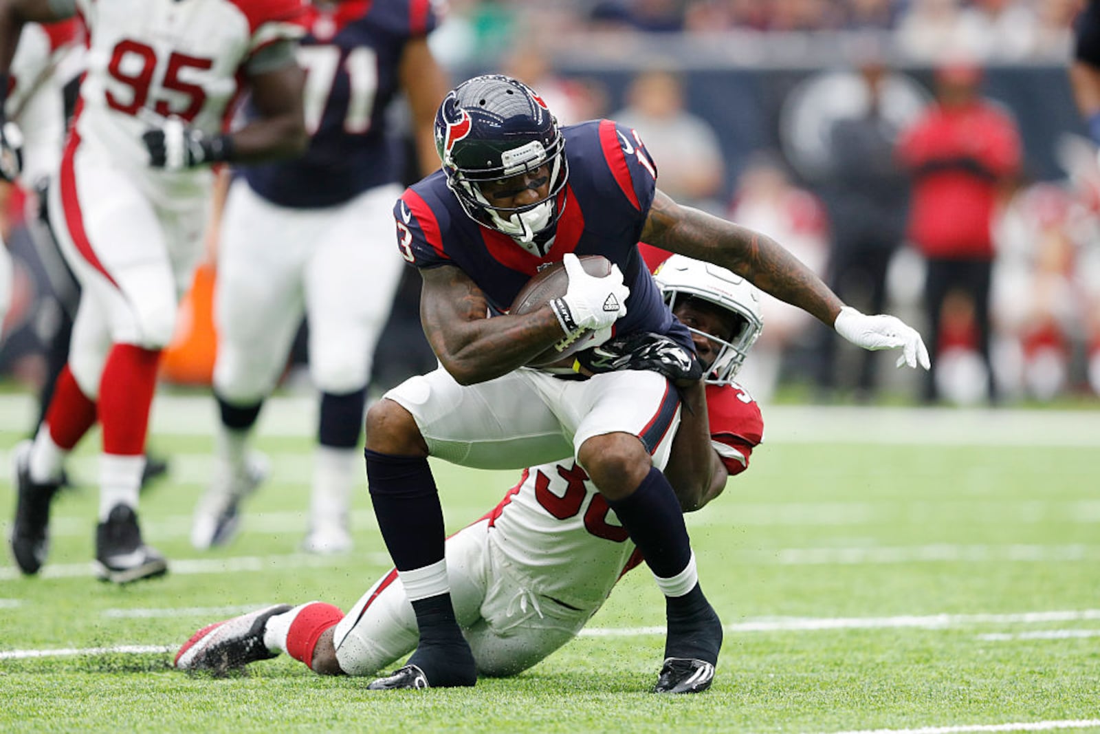 HOUSTON, TX - AUGUST 28: Braxton Miller #13 of the Houston Texans is tackled by Ronald Zamort #38 of the Arizona Cardinals after a reception in the second quarter of a preseason NFL game at NRG Stadium on August 28, 2016 in Houston, Texas. (Photo by Joe Robbins/Getty Images)