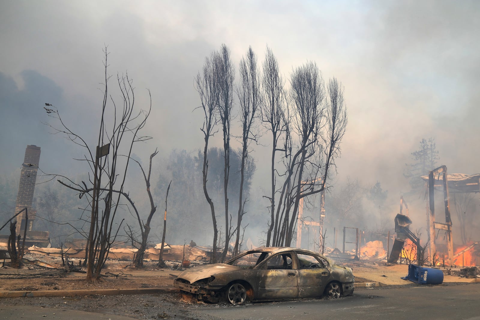 The Palisades Fire ravages a neighborhood amid high winds in the Pacific Palisades neighborhood of Los Angeles, Wednesday, Jan. 8, 2025. (AP Photo/Damian Dovarganes)