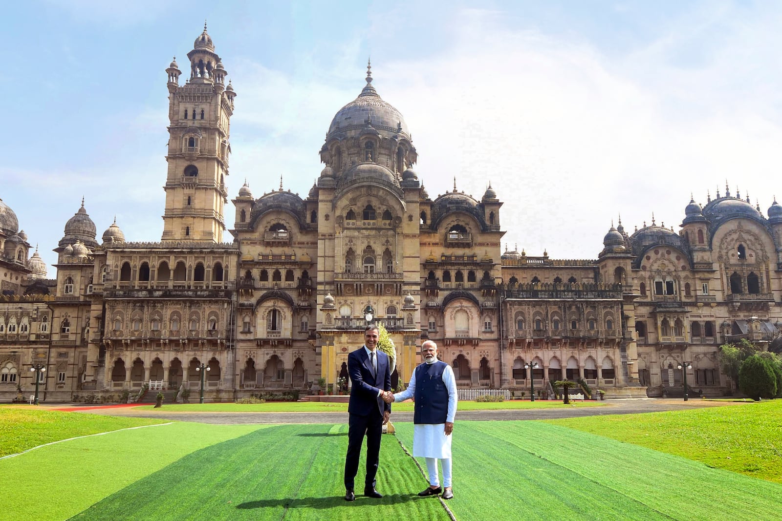 In this photo provided by the Gujarat state Press Information Bureau, Indian Prime Minister Narendra Modi, right, shakes hand with his Spanish counterpart Pedro Sanchez in front of Laxmi Vilas Palace before their meeting in Vadodara, India, Monday, Oct. 28, 2024. (Gujarat State Press Information Bureau via AP)