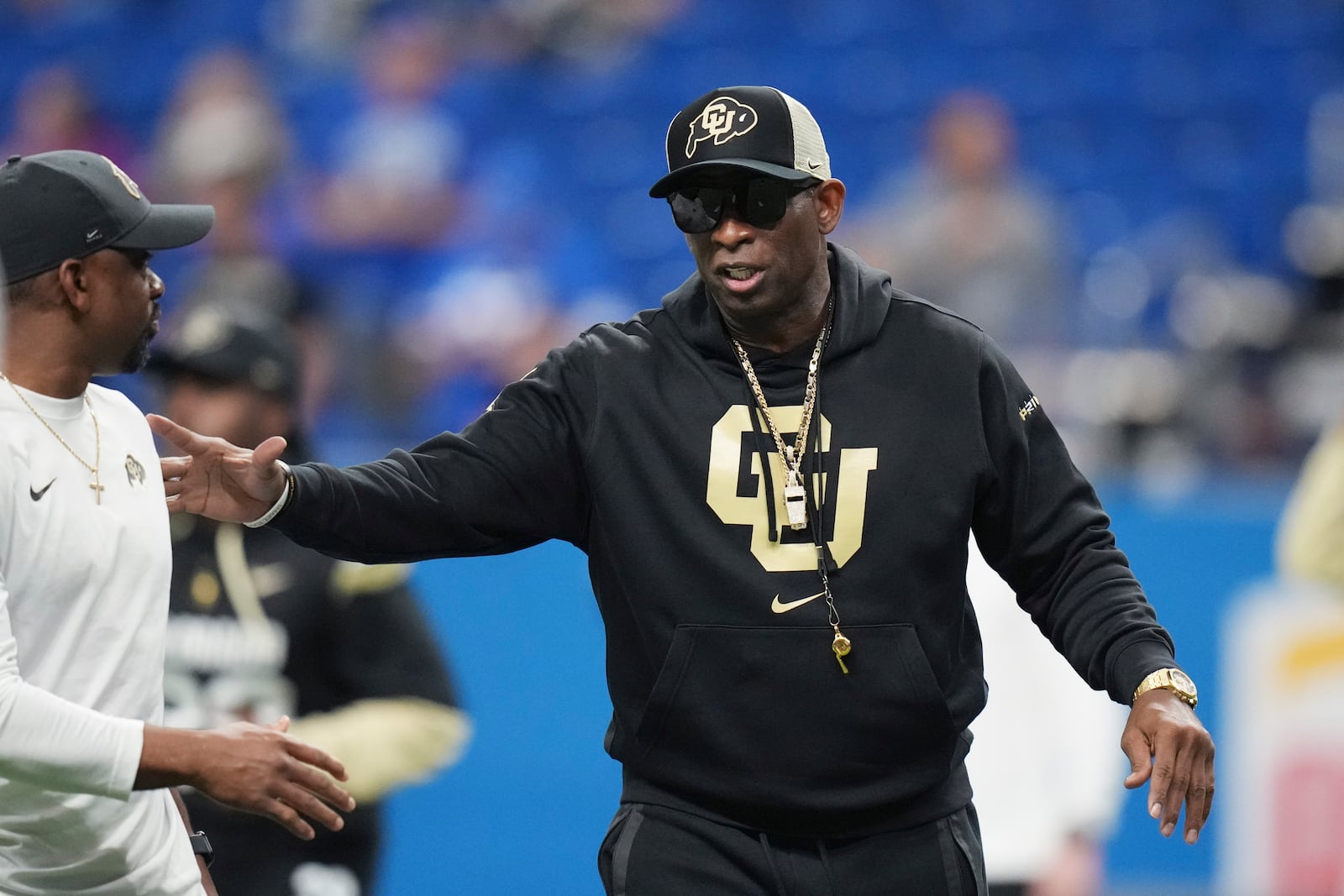 Colorado head coach Deion Sanders watches his players warm up for the Alamo Bowl NCAA college football game against BYU, Saturday, Dec. 28, 2024, in San Antonio. (AP Photo/Eric Gay)