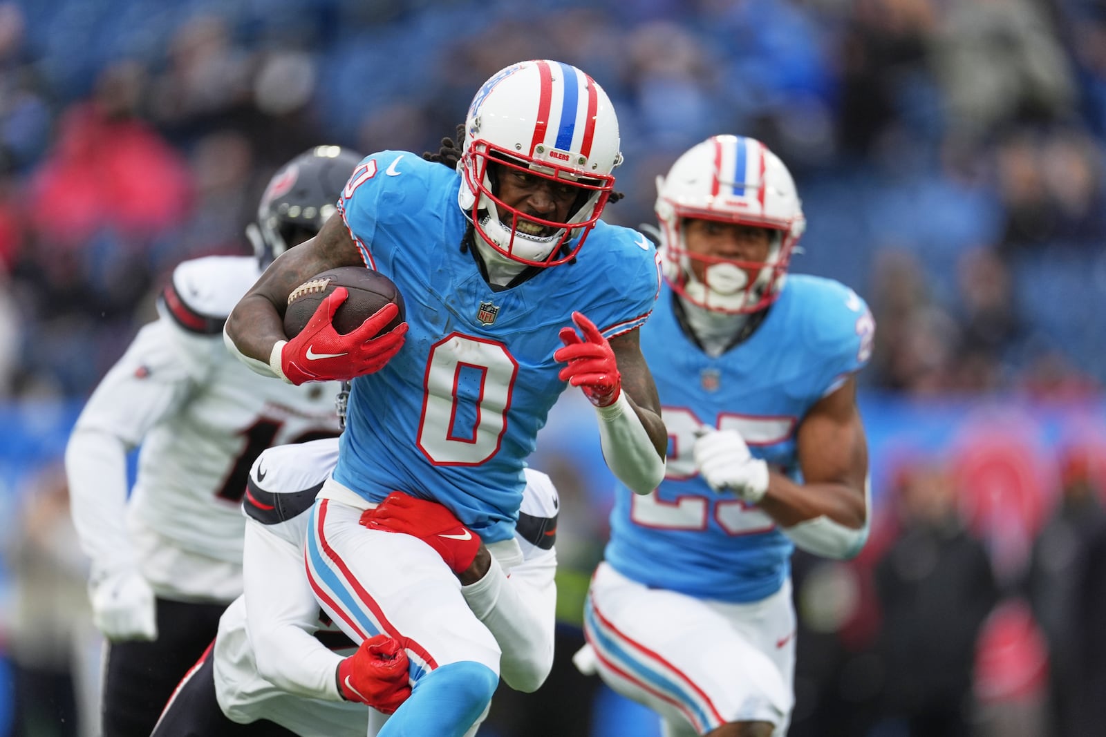 Tennessee Titans wide receiver Calvin Ridley (0) is tackled by Houston Texans safety Calen Bullock after catching a pass during the first half of an NFL football game Sunday, Jan. 5, 2025, in Nashville, Tenn. (AP Photo/George Walker IV)