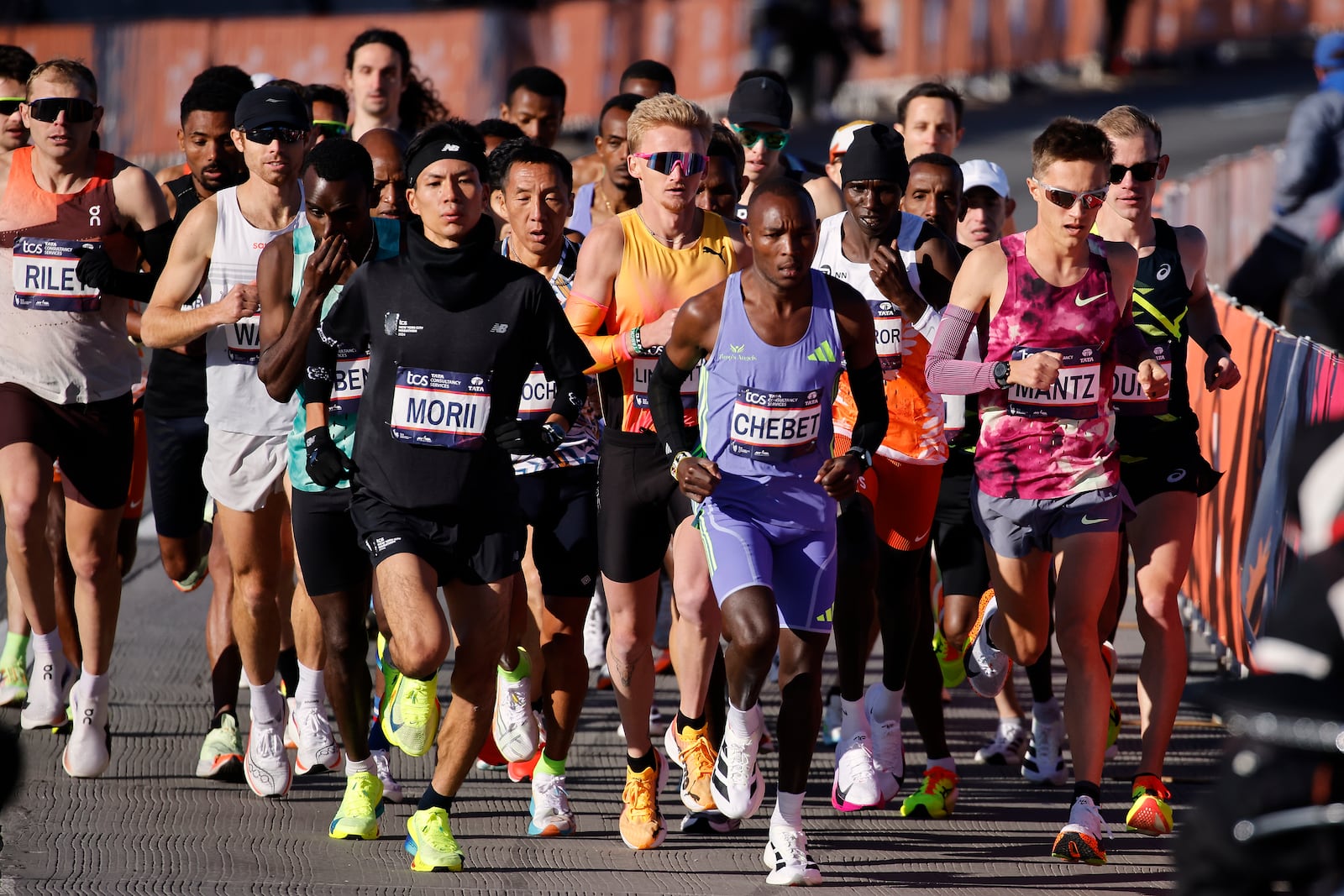 Yuma Morii, left, of Japan, makes his way onto the Verrazzano Narrows bridge with runners in the men's elite division make their way from the start line during the New York City Marathon, Sunday, Nov. 3, 2024, in New York. (AP Photo/Eduardo Munoz Alvarez)