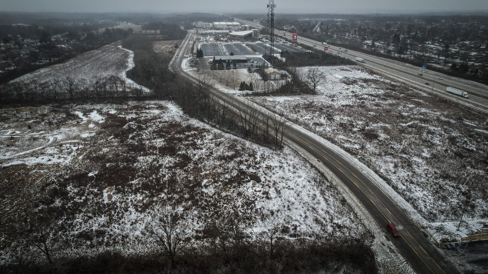 The city of Huber Heights purchased land on the north and south side of Executive Boulevard, in the center. In the background is the Rose Music Center and Warped Wing. Interstate 75 is on the far right. JIM NOELKER/STAFF