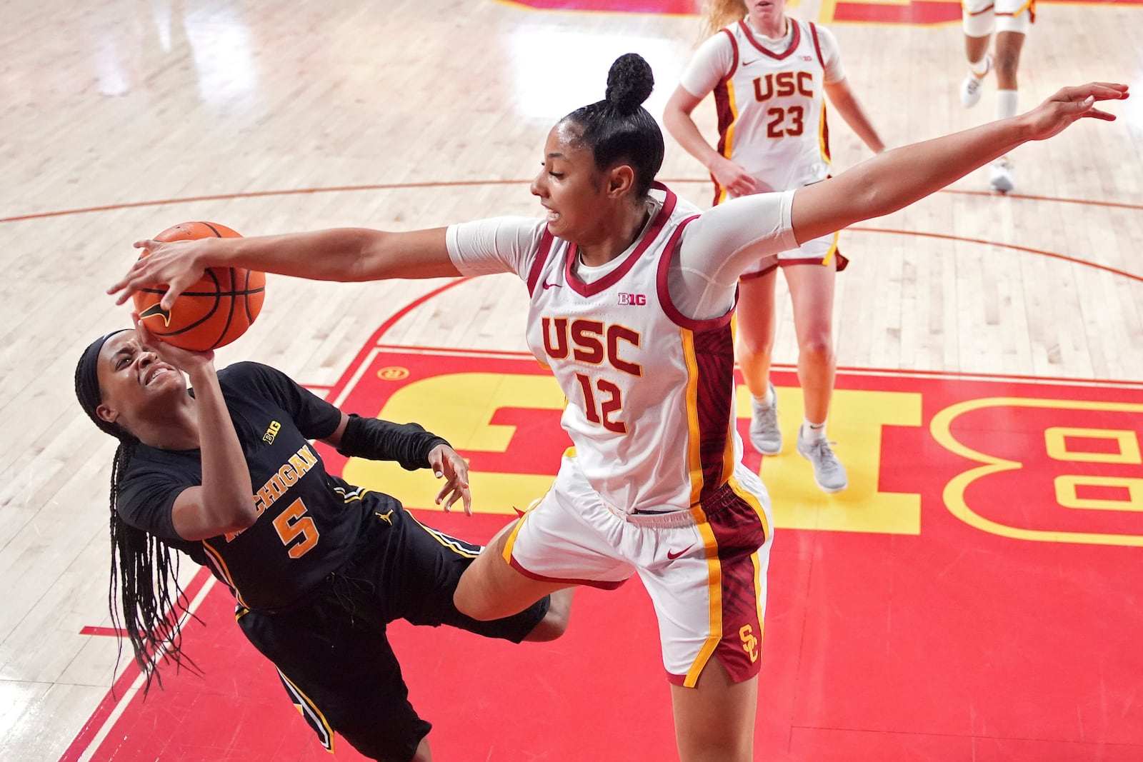 Michigan guard Brooke Daniels, left, has her shot blocked by Southern California guard JuJu Watkins during the second half of an NCAA college basketball game, Sunday, Dec. 29, 2024, in Los Angeles. (AP Photo/Mark J. Terrill)