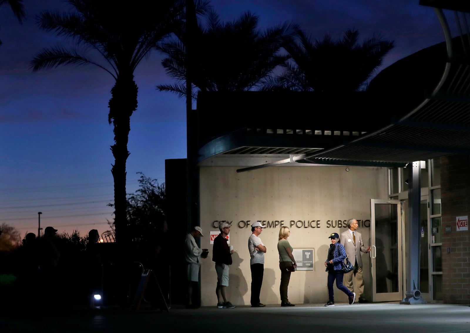 FILE - Voters wait in line to vote at their polling station early, Tuesday, Nov. 8, 2016, in Tempe, Ariz. (AP Photo/Matt York, File)